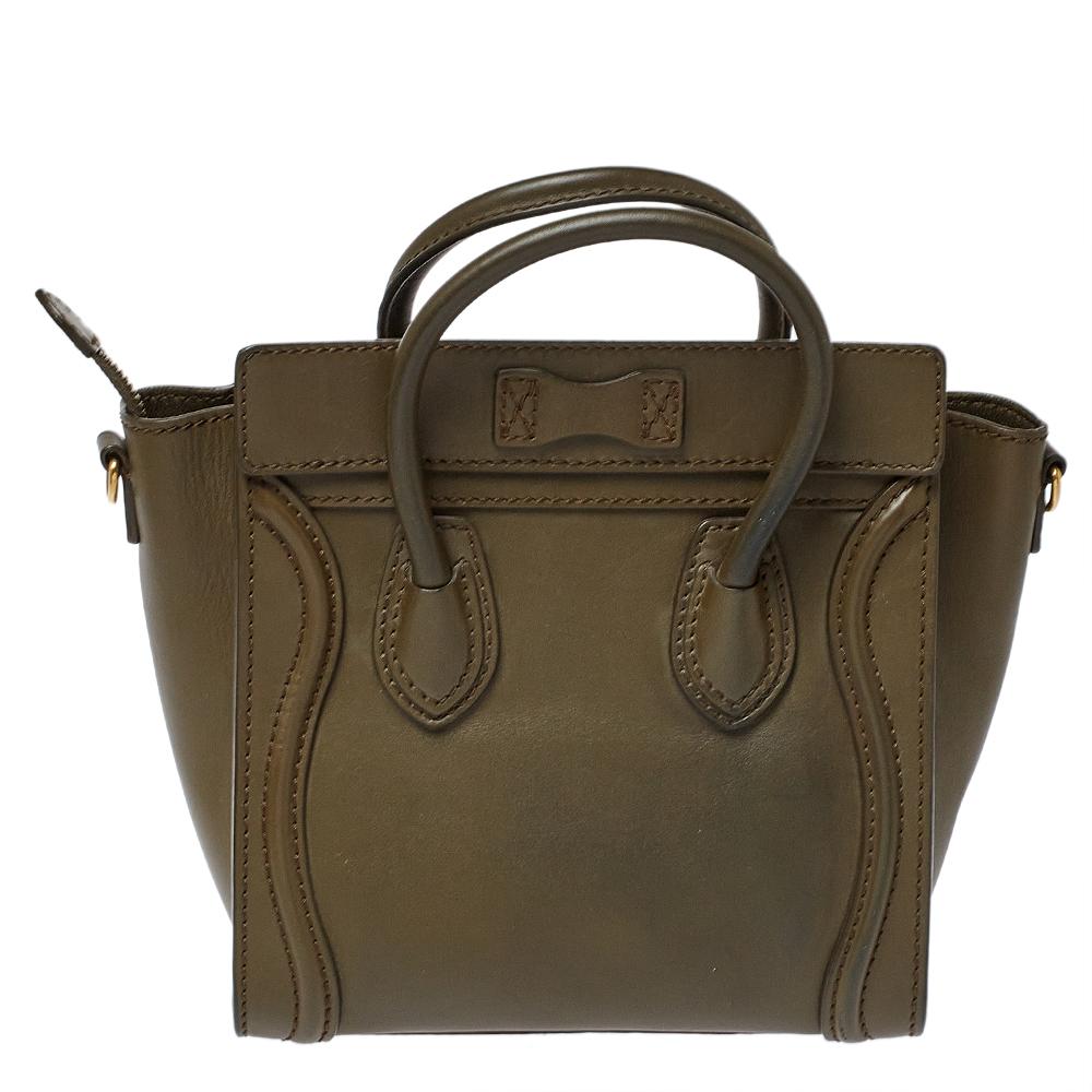 The Nano Luggage tote from Celine is one of the most popular handbags in the world. This tote is crafted from leather and designed in an olive green shade. It comes with rolled top handles, a detachable shoulder strap, and a front zip pocket. The
