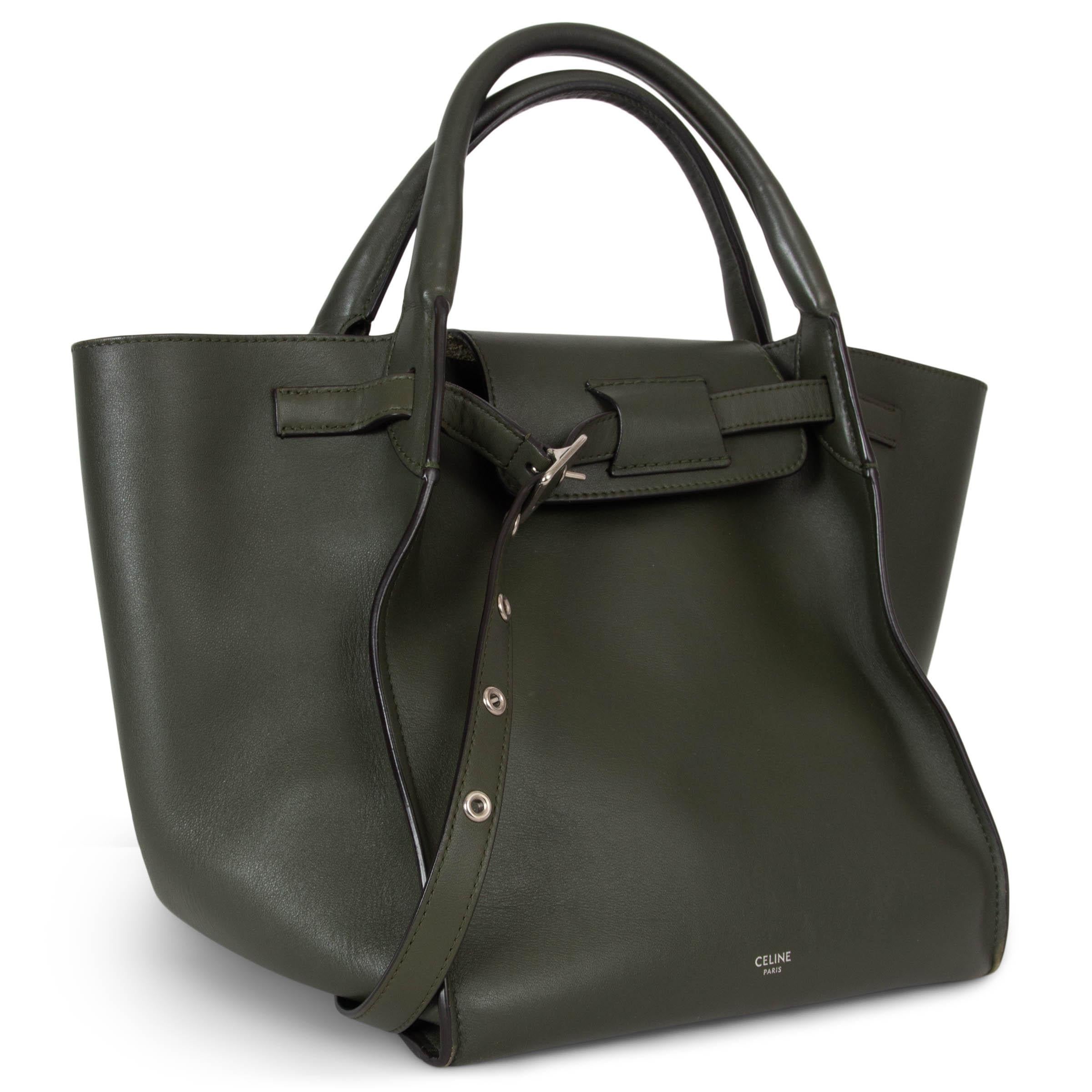 This 100% authentic Céline Medium Big Bag in olive green smooth calf leather is a timeless statement piece. Featuring a minimalist design, it closes with a front belt for a sleek finish and is accented with silver-tone hardware. The spacious
