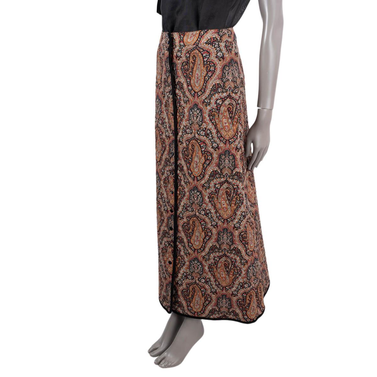 100% authentic Celine 2020 buttoned and quilted paisley maxi skirt in black, beige, orange, red and ecru wool (100%) with a black silk (100%) lining. The design features a black embroidered hem, quilt stitching and two slit side pockets. Has been