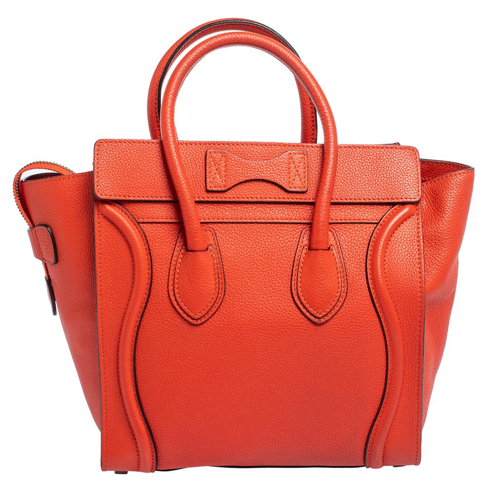 The micro Luggage tote from Celine is one of the most popular handbags in the world. This tote is crafted from leather and designed in an orange shade. It comes with rolled top handles and a front zip pocket. The bag is equipped with a well-sized