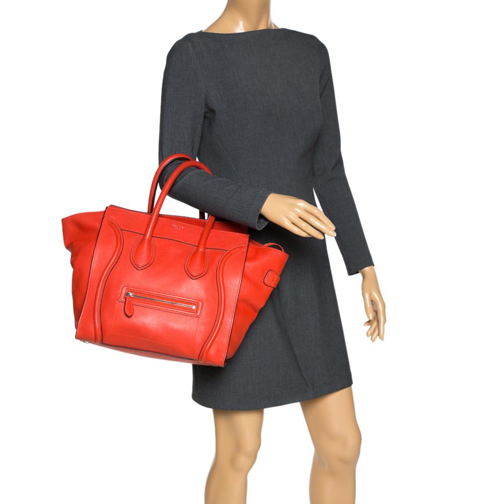 The mini Luggage tote from Celine is one of the most popular handbags in the world. This tote is crafted from leather and designed in orange. It comes with rolled top handles and a front zip pocket. The bag is equipped with a well-sized suede