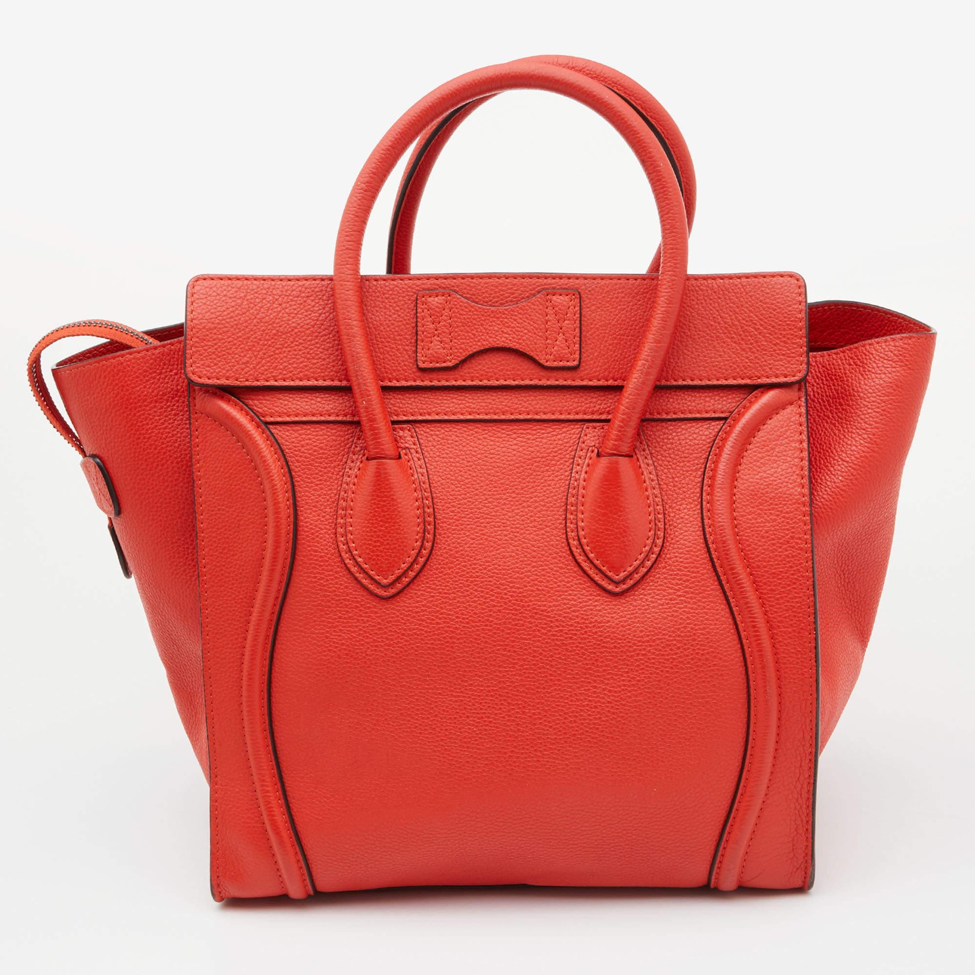 The usage of orange leather on the exterior gives this Celine tote a classy appeal. An eye-catching accessory, the bag features a front zipper pocket, dual handles at the top, and silver-tone hardware. The Alcantara-lined interior is equipped to