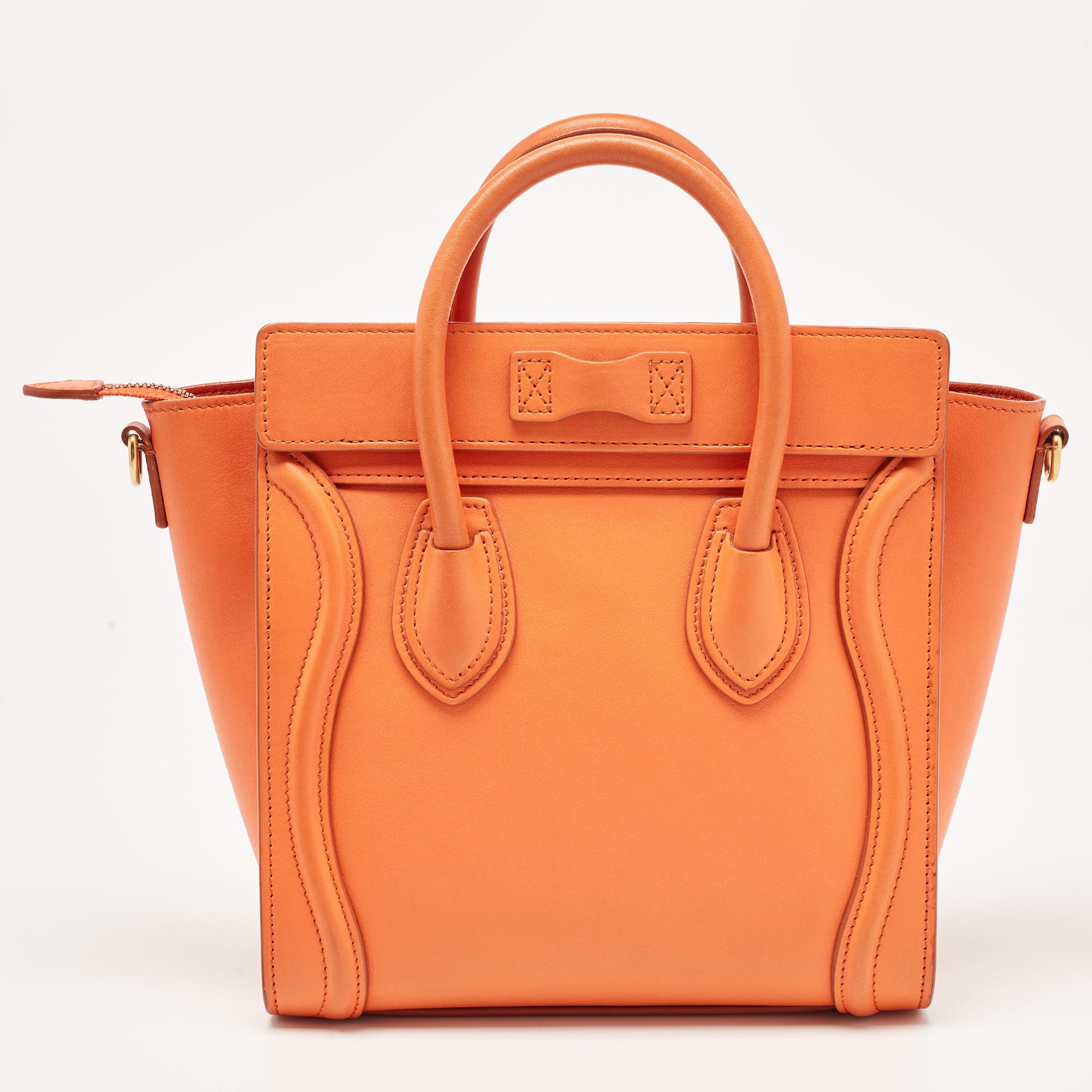 The Luggage tote from Celine is one of the most popular handbags in the world. This tote is crafted from leather and designed in an orange hue. It comes with rolled top handles and a front zip pocket. The bag is equipped with a well-sized suede
