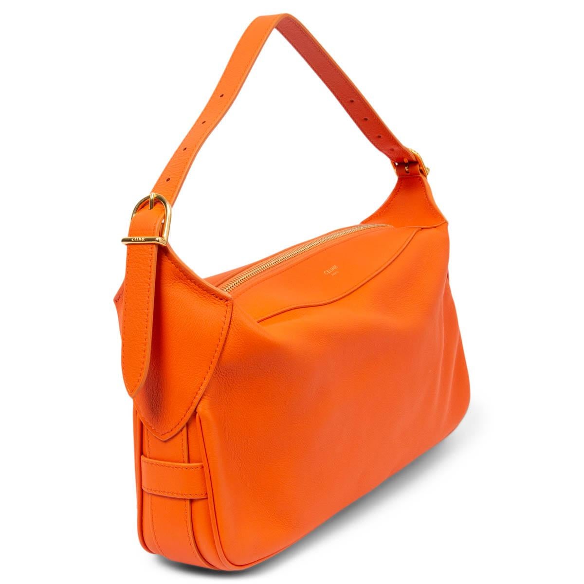 100% authentic Celine Medium Romy shoulder bag in orange supple calfskin featuring gold-tone hardware. Opens with a zipper on top and is lined in orange suede. The design comes with a adjustable handle. Has been carried and is in virtually new