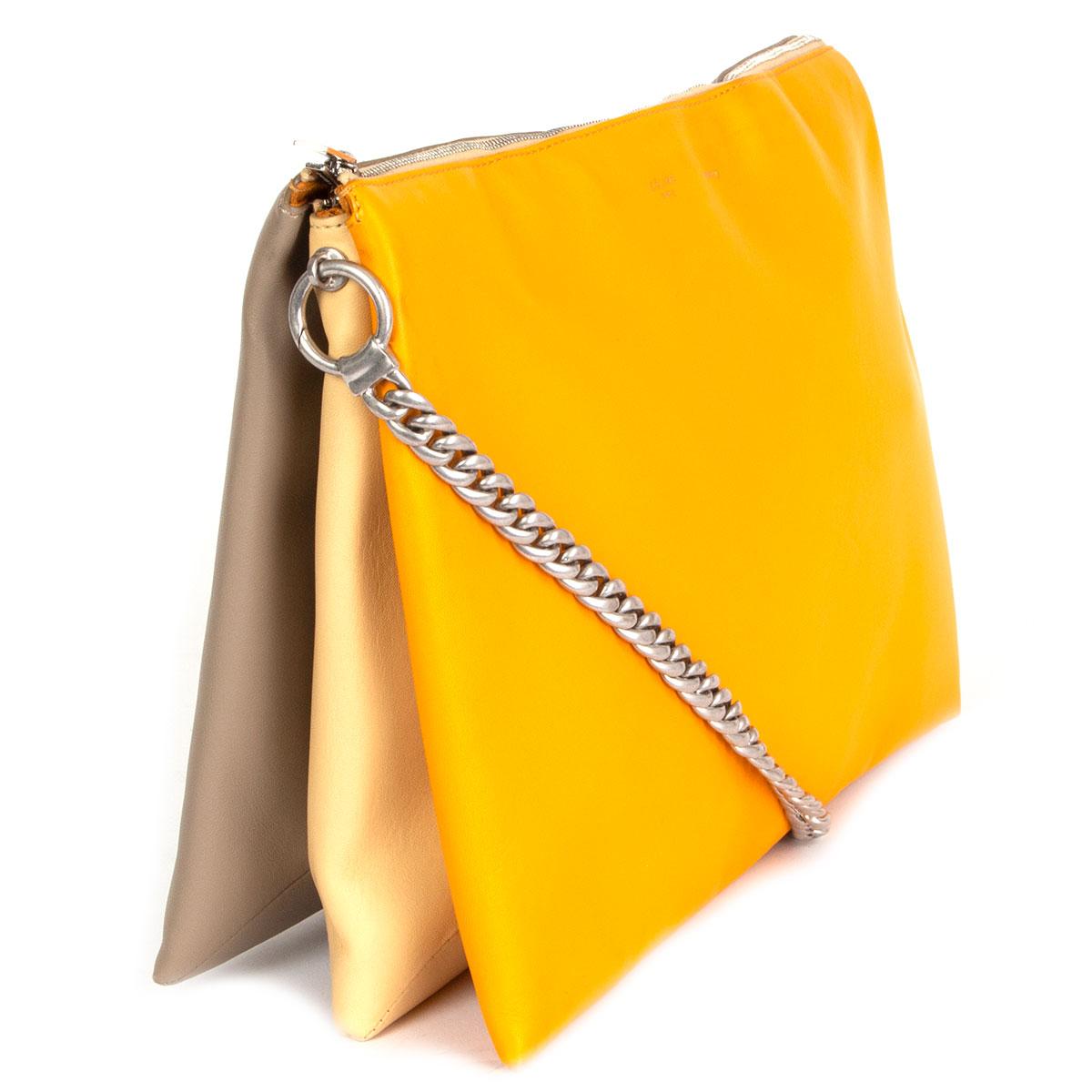 100% authentic Céline 'Soft Trio Chain' shoulder bag in smooth orange, vanilla and taupe calfskin that opens with a zipper on top. Lined in orange suede and divided in three compartments with one big zipper pocket in the middle. Silver-tone metal