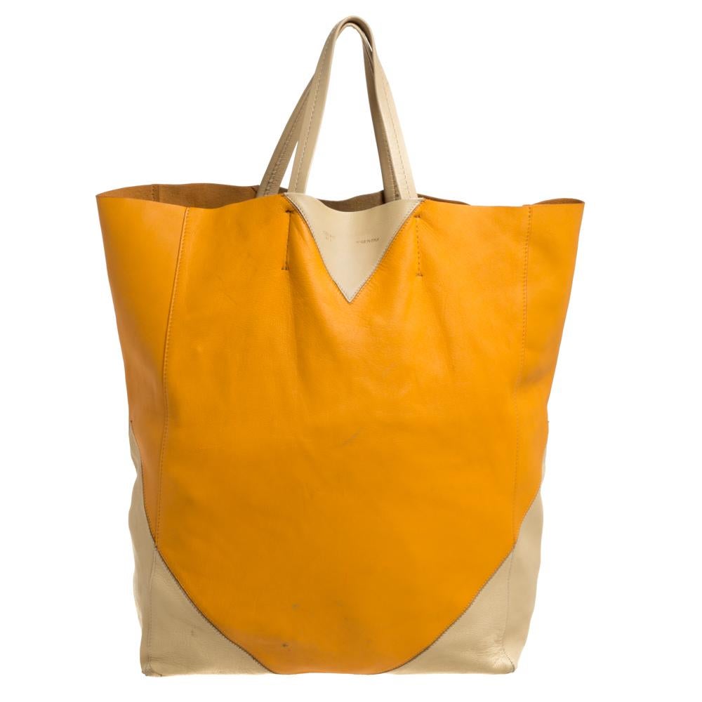 This Celine tote has a classic design and defines casual style. It is crafted from orange & yellow leather, has a vertical body, and helps you put together an easy urban look. It features convenient handles, an interior pocket, and the brand's logo