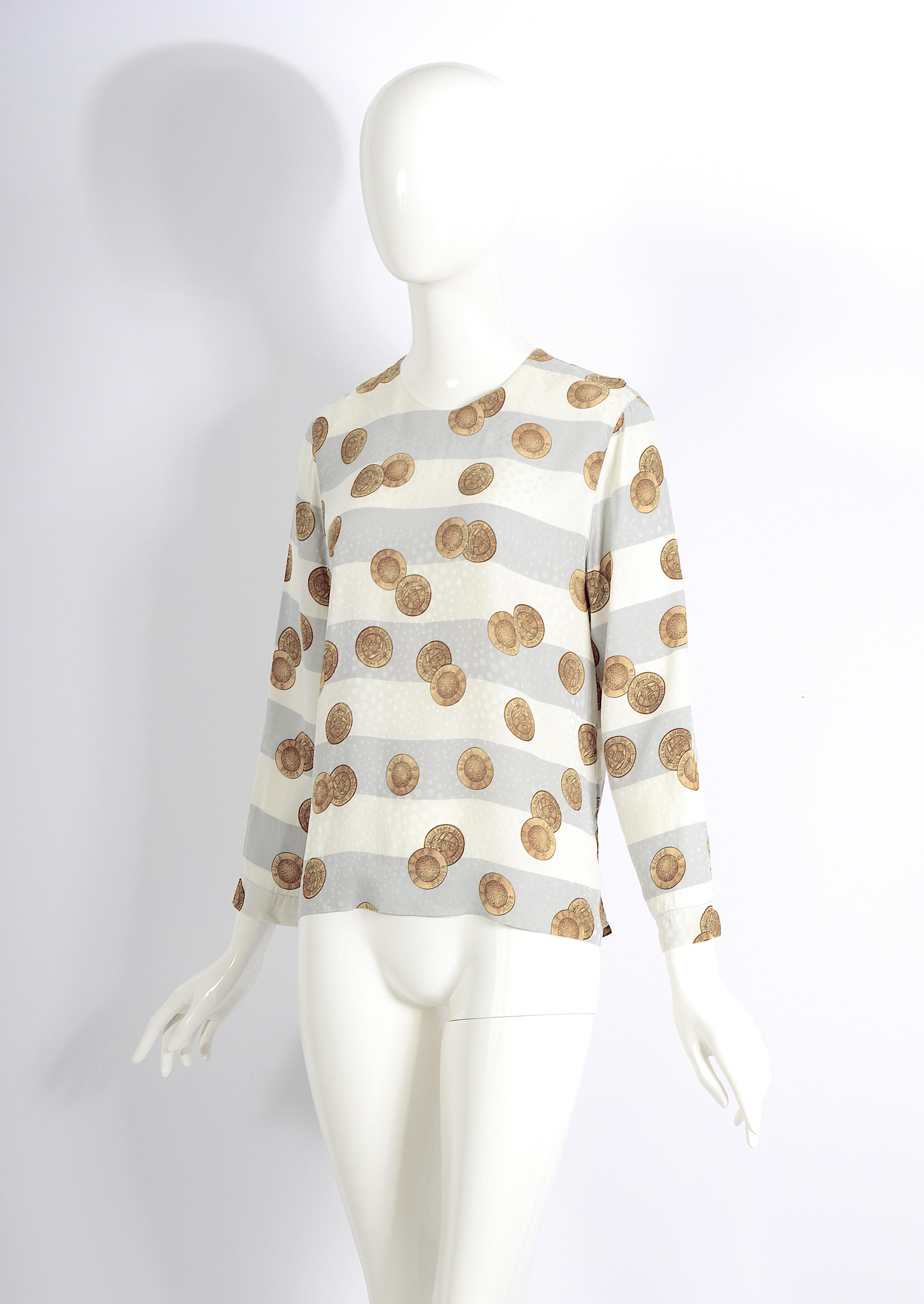 Vintage 1980s classic timeless Céline Paris 100% silk blouse featuring a cream and soft grey striped print adorned with signed Céline Paris gold coin motifs.

Measurements that are taken flat: 
Sh to Sh 15inch/38cm - Ua to Ua 19,5inch/49cm(x2) -