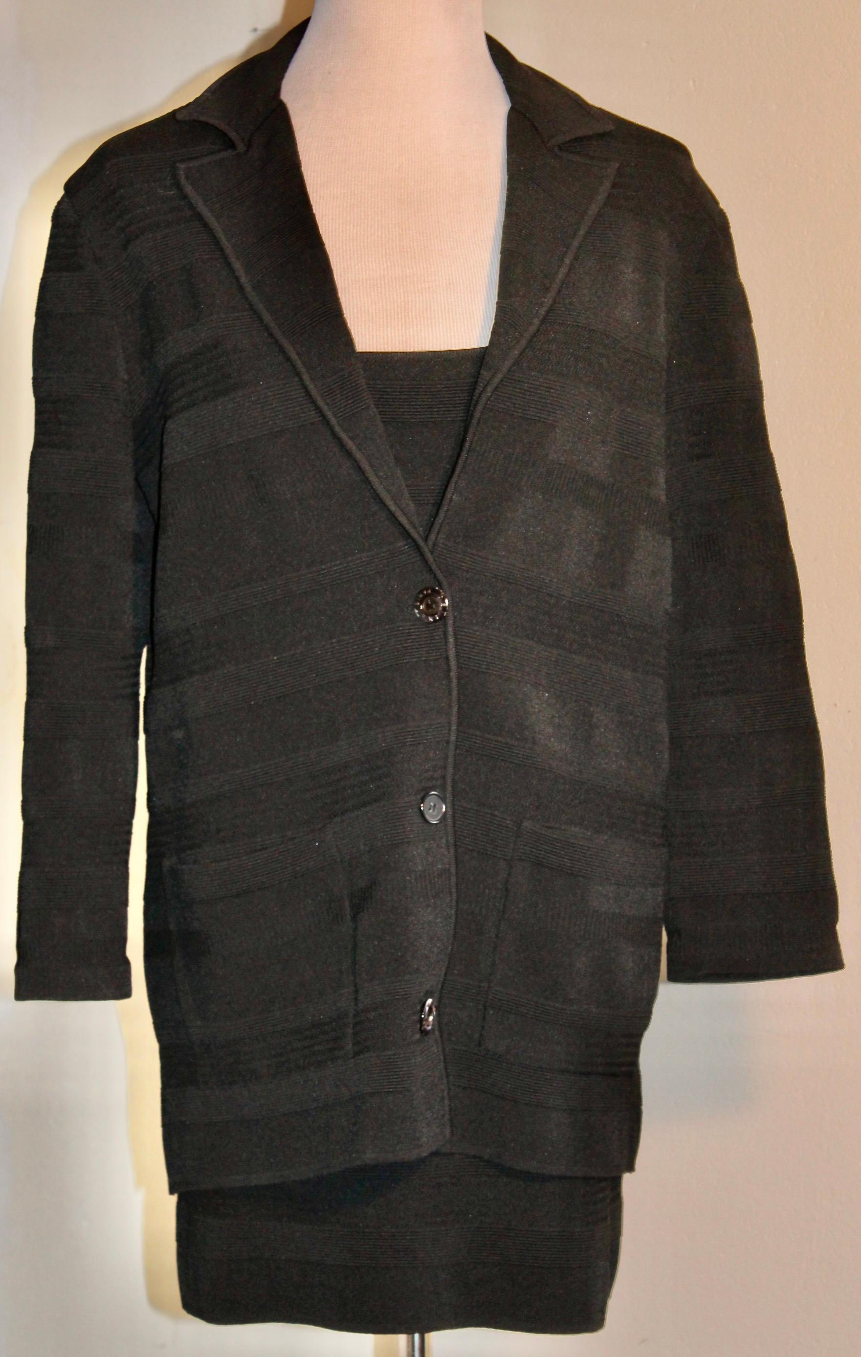 Ensemble black spaghetti straps short black dress and a long black jacket. Both in the same stretchy horizontal geometric woven design fabric.  Dress is an EU 40, and the jacket EU 38. Jacket length is 28