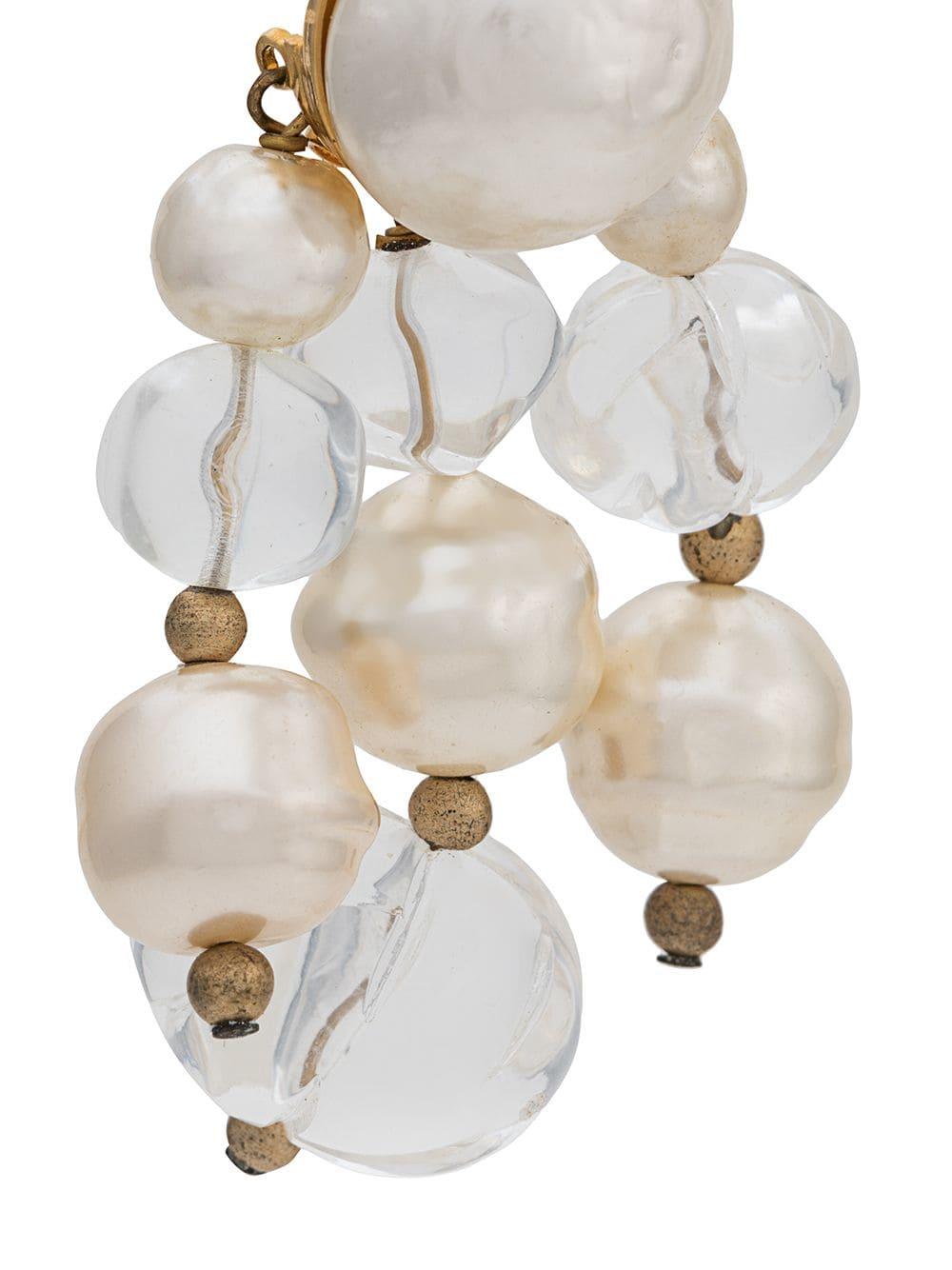 Add a little Parisian sophistication to your look with a pair of pre-owned, drop earrings from Céline, designed for the optimum elegance with cream-coloured faux-pearl and transparent crystal embellishments, antique gold-plated brass accents and a