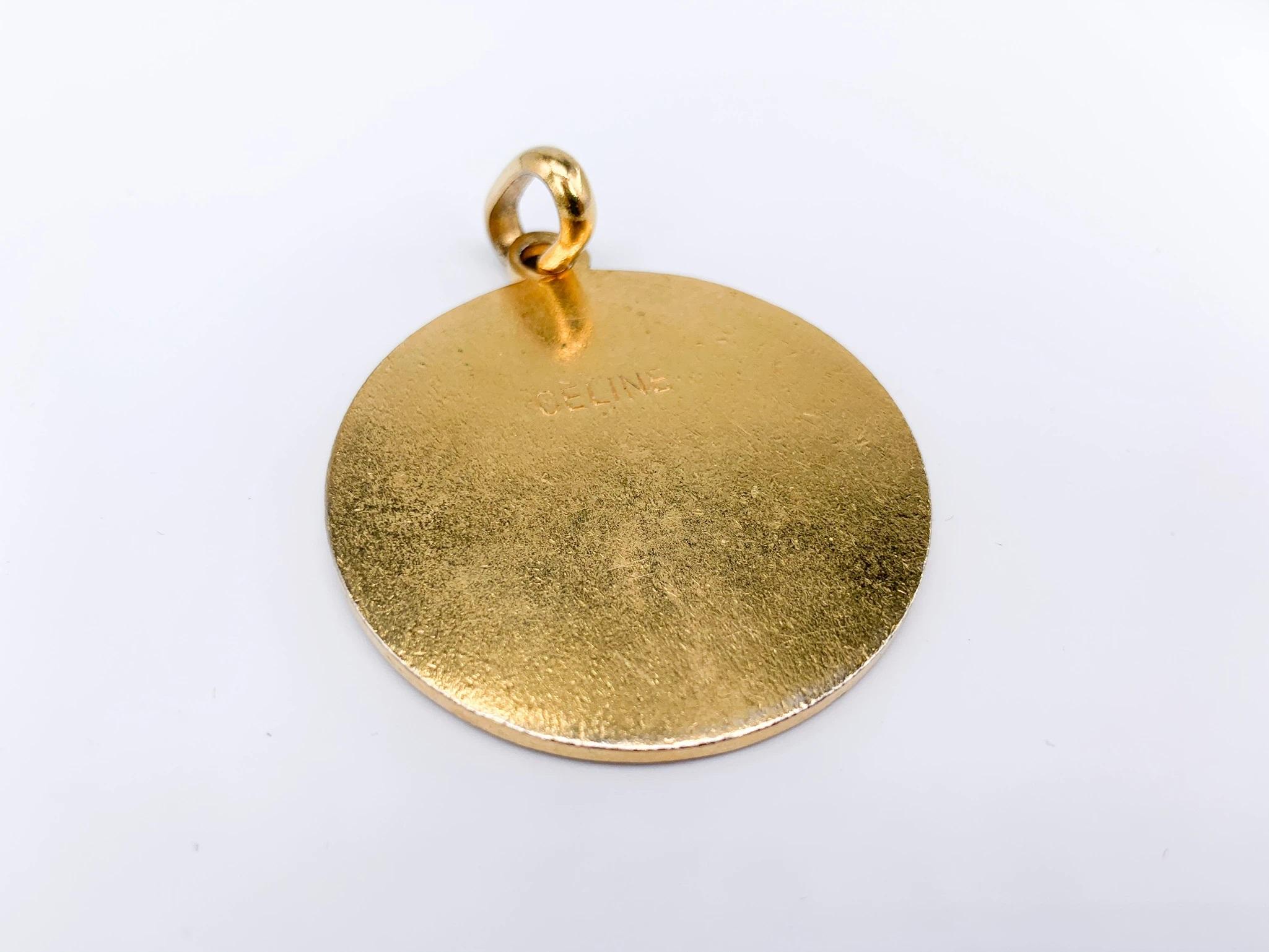 Celine 1970s Vintage Pendant. 

Super cool large pendant from the 70s archive of the iconic House of Celine. 

Detail
-Gold plated metal
-Inlaid with black enamel
-Features the iconic macadam Celine logo

Authenticity & Condition
-Fully examined and