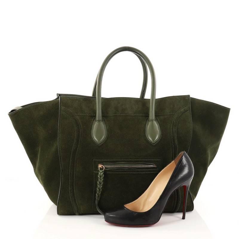 This authentic Celine Phantom Handbag Suede Large is one of the most sought-after bags beloved by fashionistas. Crafted from green suede, this oversized, minimalist tote features a braided zipper pull, dual-rolled handles, zip front pocket,