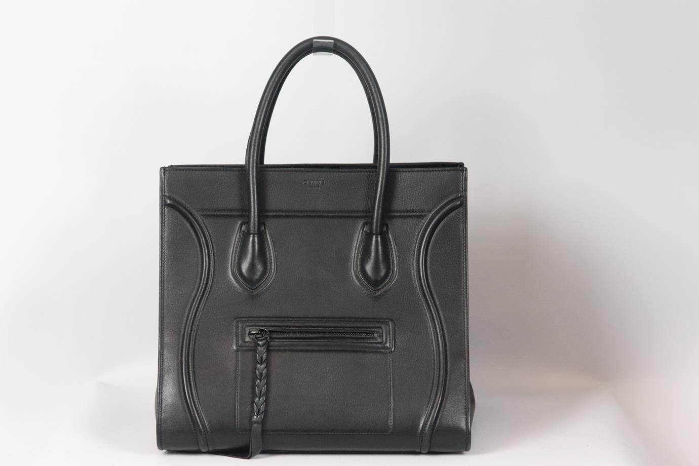 Celine Phantom medium leather tote bag. Black. Open top. Comes with dustbag. Height: 11 in. Width: 12 in. Depth: 10 in. Handle Drop: 5 in. Good condition - Some light indentations on base. Light scuffing to outer material at the corners. Some signs