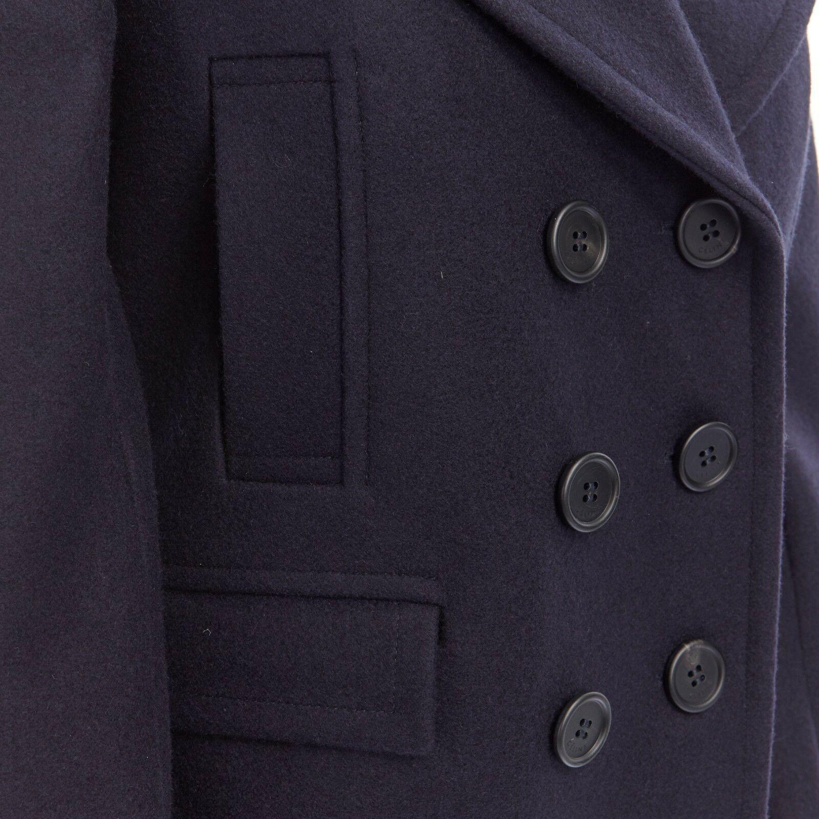 CELINE PHILO navy blue 100% wool wide collar double breasted coat jacket FR36 S

CELINE BY PHOEBE PHILO
100% wool. Navy blue. Extra wide collar. Double breasted button front closure. 4-pocket design. Long sleeves. Dual back vent. Binded seams at