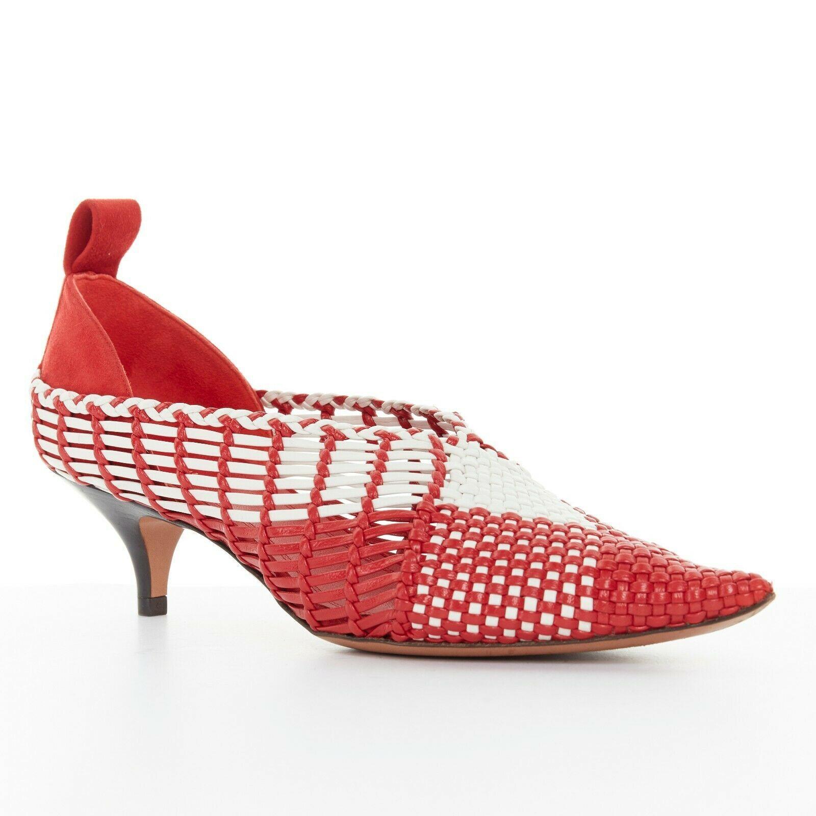 CELINE PHILO red white checkered woven leather pointy kitten hee pumpl EU38
CELINE BY PHOEBE PHILO 
Red and white checkered upper. 
Composed of woven leather strips. 
V-neck. 
Pointed toe. 
Suede covered heel. 
Pull tab detail at heel. 
Wooden