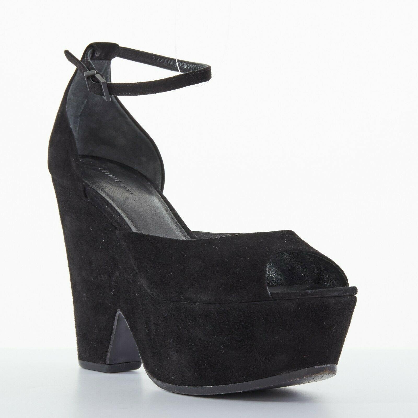 CELINE PHOEBE PHILO black suede cut out platform wedge ankle cuff heels EU36
CELINE BY PHOEBE PHILO
Black suede leather upper. 
Suede covered platform. 
Cut out detail at wedge. 
Peep toe. 
Covered heel. 
Ankle strap closure. 
Tonal stitching. 
Made