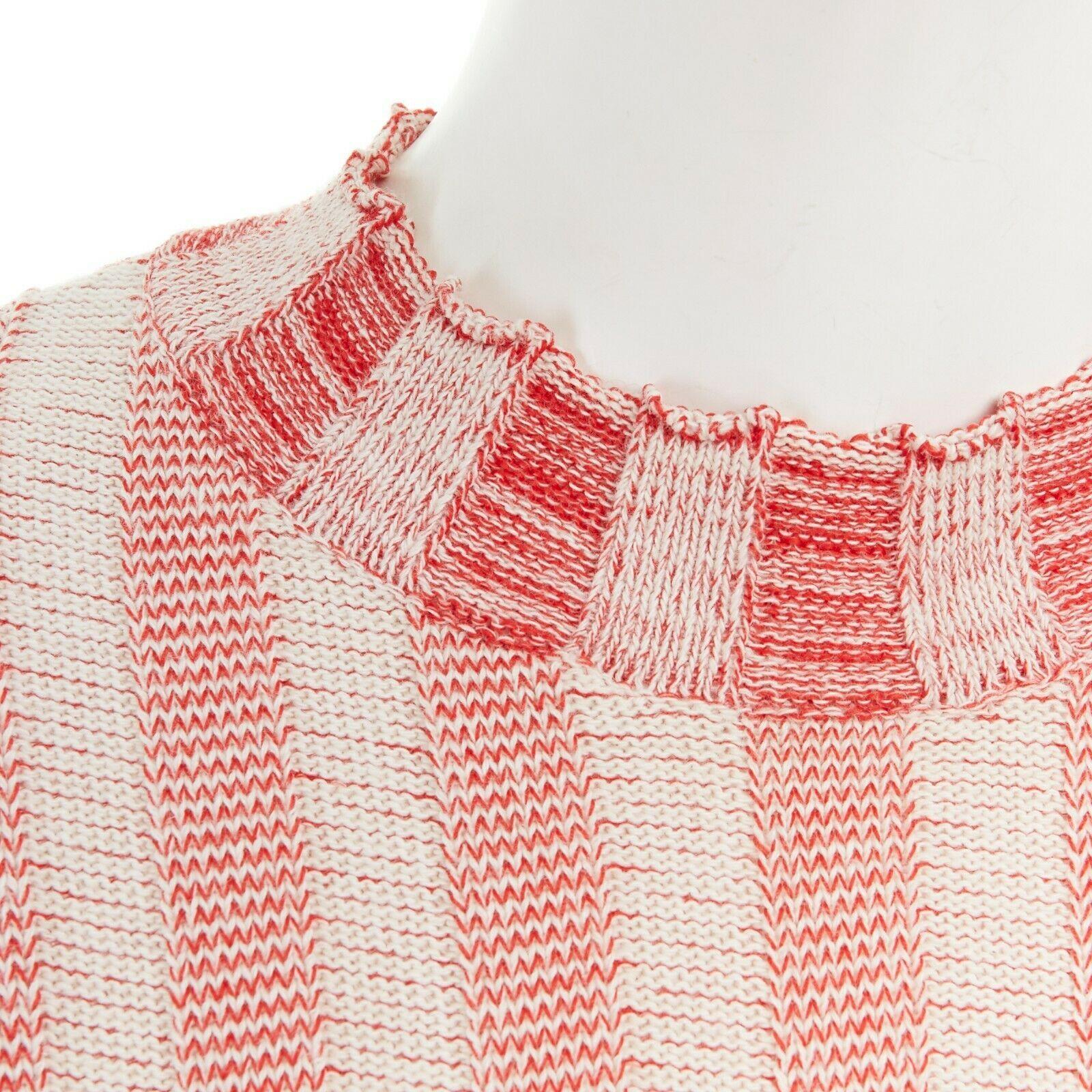 CELINE PHOEBE PHILO cotton blend red beige stripe ribbed knit sweater top M

CELINE BY PHOEBE PHILO
Cotton, polyester. Red and beige stripe. Round neck. Long sleeves. Contrast mismatched stripe panel at back. Cream block hem at back. Stepped hem.