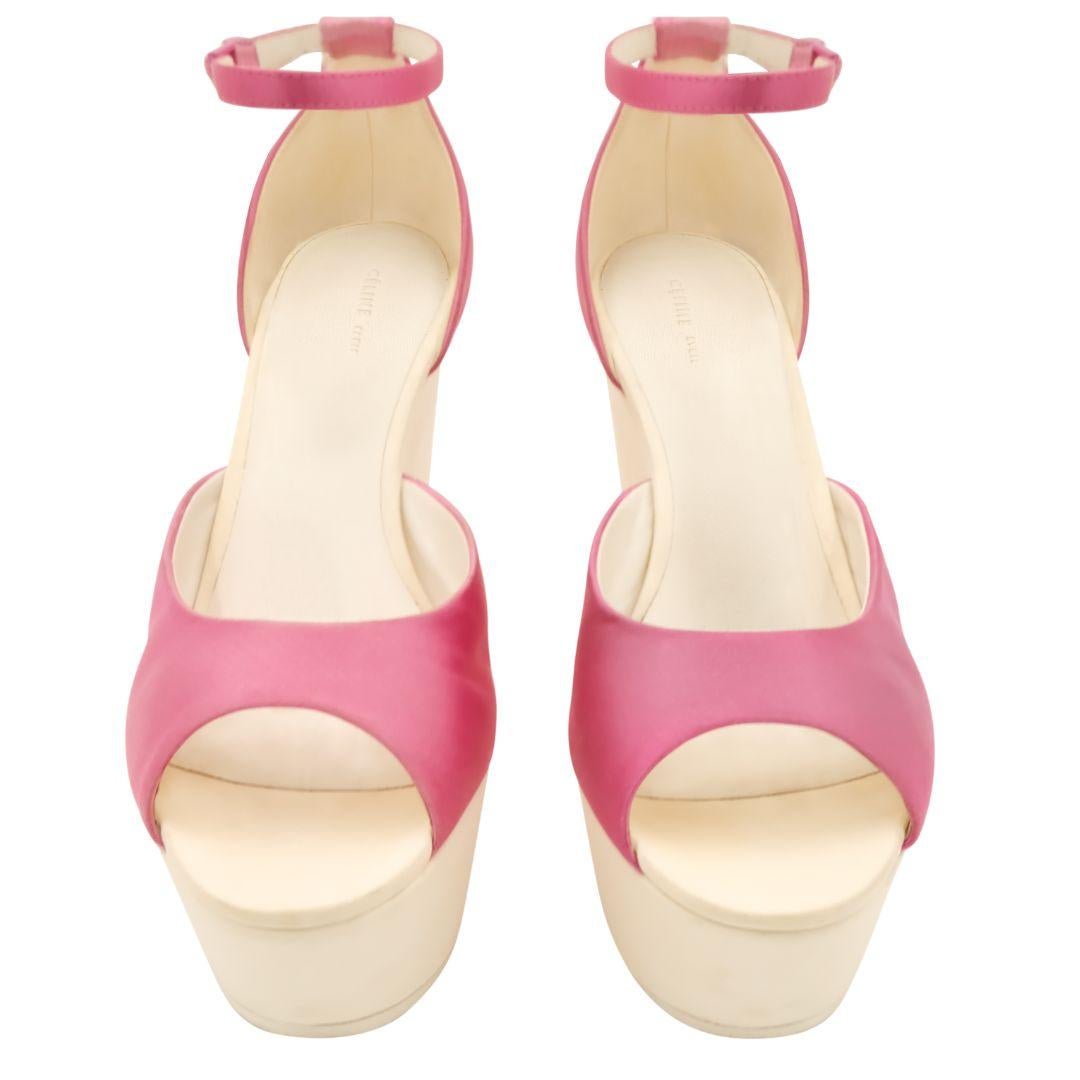 Pink satin open rounded toe sandals with ankle strap and white leather platform heels with cutout detail.

Condition Details: Good, gently used condition. Some minor scratches and a few dents but does not affect the wearability of the item.

Refer