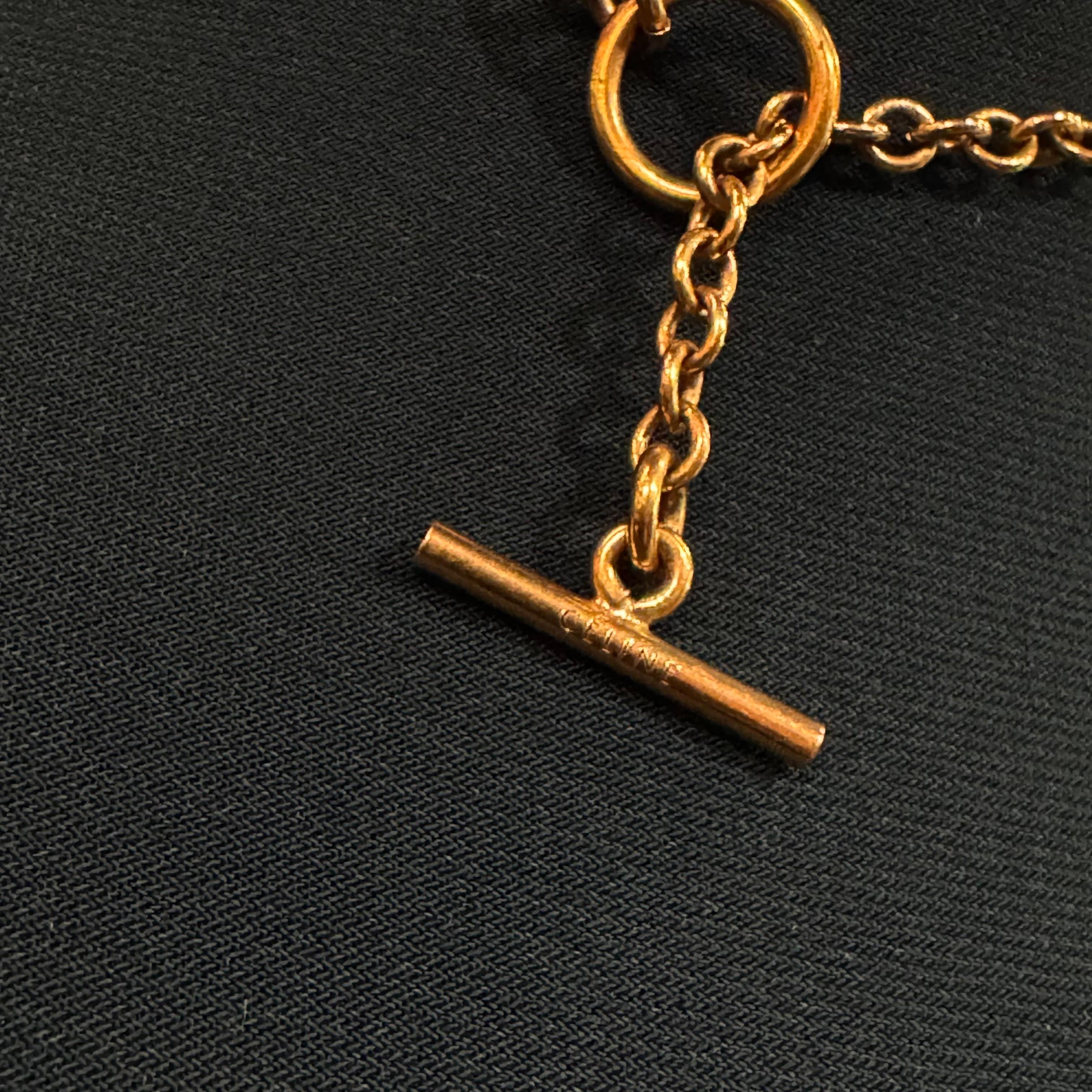 Medallion long chain necklace. As seen on mannequin, the chain is very long. When locked, the length is 58 cm. But there are 2 loops for sizing. Can be styled multiple ways (double layered, triple layered. The gold is slightly darker, almost bronze