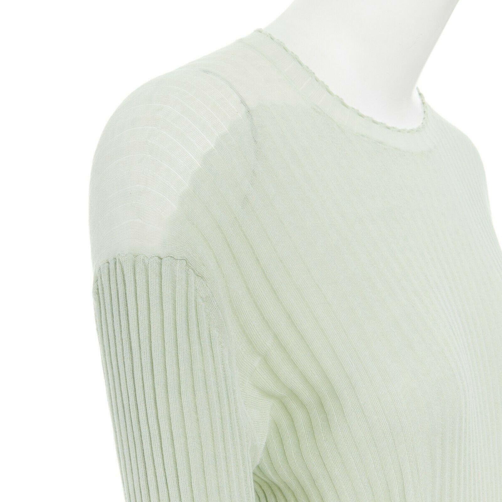 CELINE PHOEBE PHILO mint green ribbed sheer back step hem sweater top M

CELINE BY PHOEBE PHILO
100% cotton. Mint green. Round neck. Dropped shoulder. Extra long sleeves. White ribbing detail at cuff. Slightly sheer detail along shoulders. Contrast