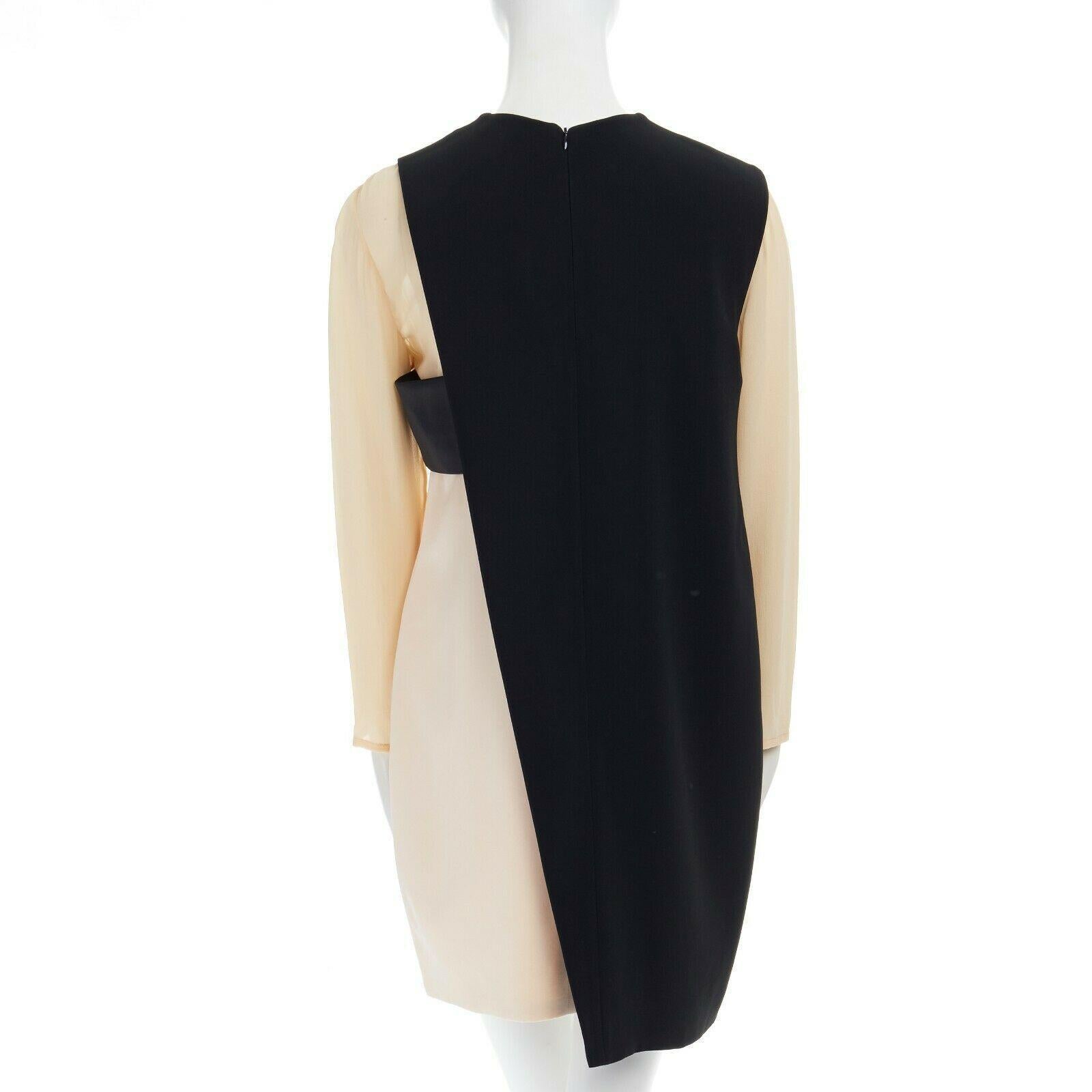 CELINE PHOEBE PHILO nude black asymmetric layered silk sleeve shift dress FR38

CELINE BY PHOEBE PHILO
Nude and black. Faux layered design. Round neck. Semi-sheer silk long sleeves. Asymmetric black attached layer design. Silk band at bust.