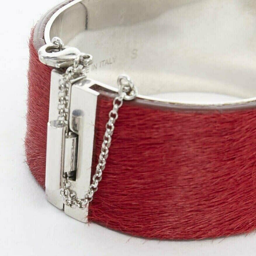 CELINE PHOEBE PHILO red horse hair leather silver hardware chained bangle cuff S 
Reference: TGAS/A01279 
Brand: Celine 
Designer: Phoebe Philo 
Material: Leather 
Color: Red 
Extra Detail: Red horsehair leather outer. Silver hardware. Silver