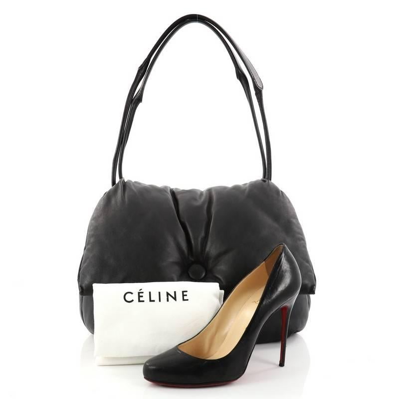 This authentic Celine Pillow Shoulder Bag Leather is from the brand's Spring 2016 Collection by Phoebe Philo. Crafted from black leather, this bag features dual flat shoulder straps, foil-stamped logo accent at front and silver-tone hardware