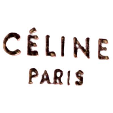 A functional and smart creation from Celine will keep your cash and cards organized and secured. Crafted from pink and beige leather, it is accented with gold-tone hardware. It comes with a zip around closure that opens to reveal multiple card