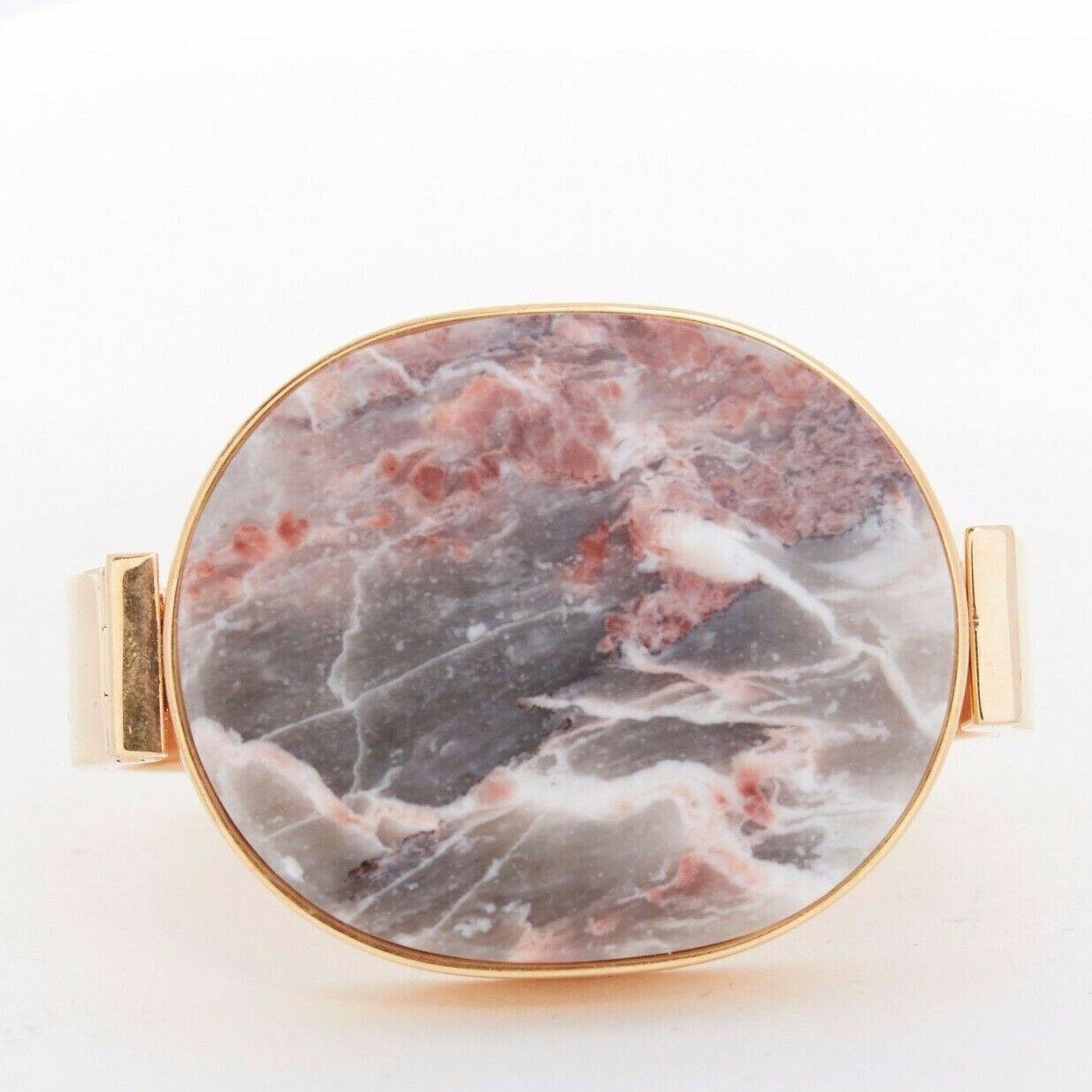 CELINE pink grey signet marble stone face gold-tone metal bracelet cuff bangle S

CELINE BY PHOEBE PHILO
Signet bangle. Grey and pink marble stone face. Gold-tone metal. Clasp closure. Signed Celine Made in Italy.

CONDITION
Very good, this item was
