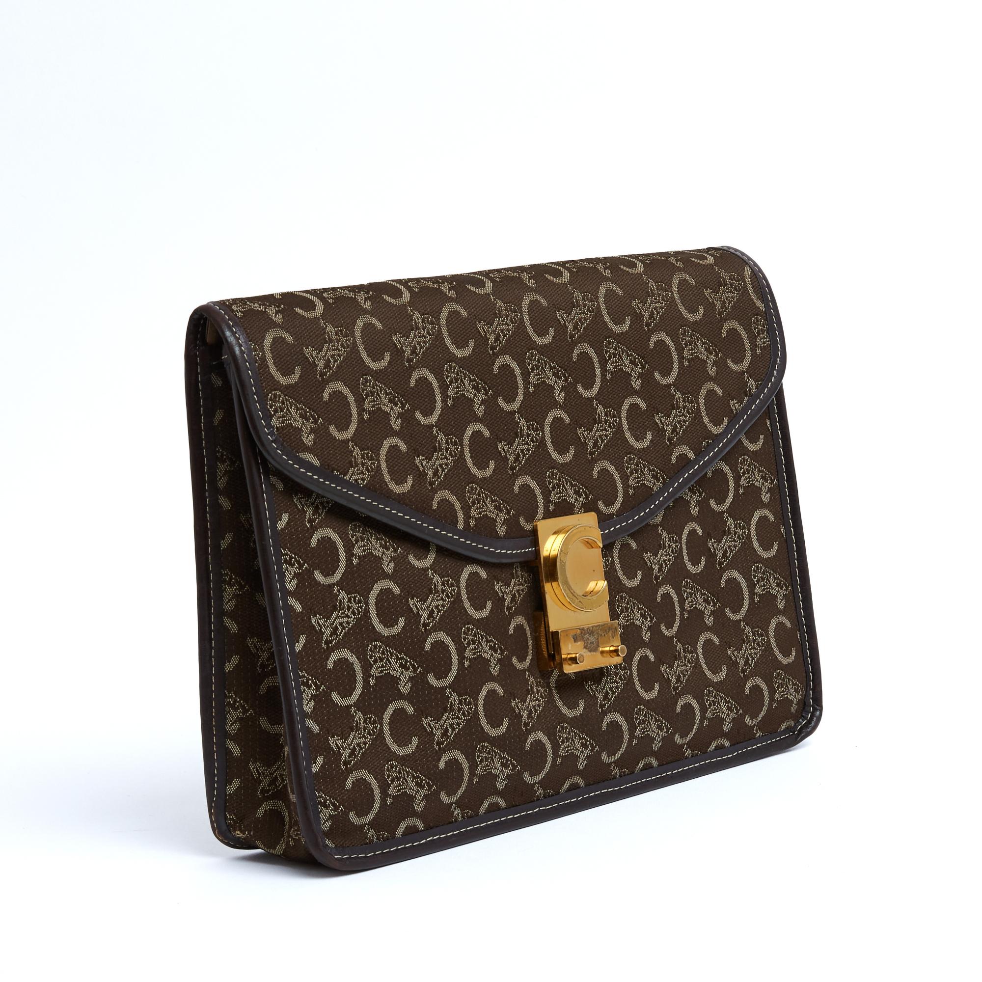 Céline circa 1985 Diamond Clutch (or Envelope) shaped pouch in brown Monogram Calèche canvas trimmed with matching leather, brown leather interior with a central zipped pocket, gold metal Céline tilting clasp. Width 25.5 cm x height 19.5 cm x depth