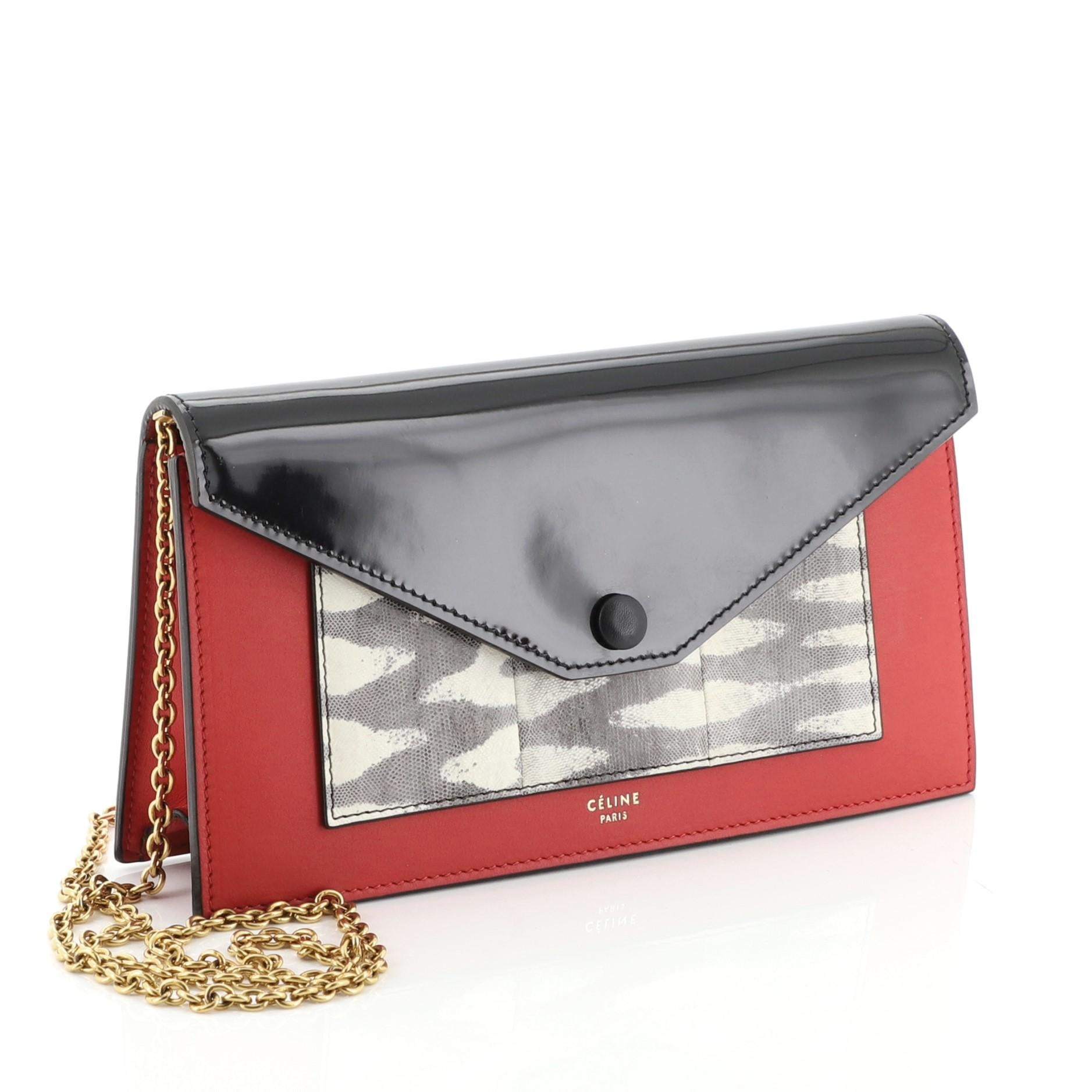 This Celine Pocket Envelope Wallet on Chain Leather and Lizard Small, crafted from red leather and genuine lizard , features gold chain-link strap, envelope flap, Celine stamped logo, and gold-tone hardware. Its snap button closure opens to a red