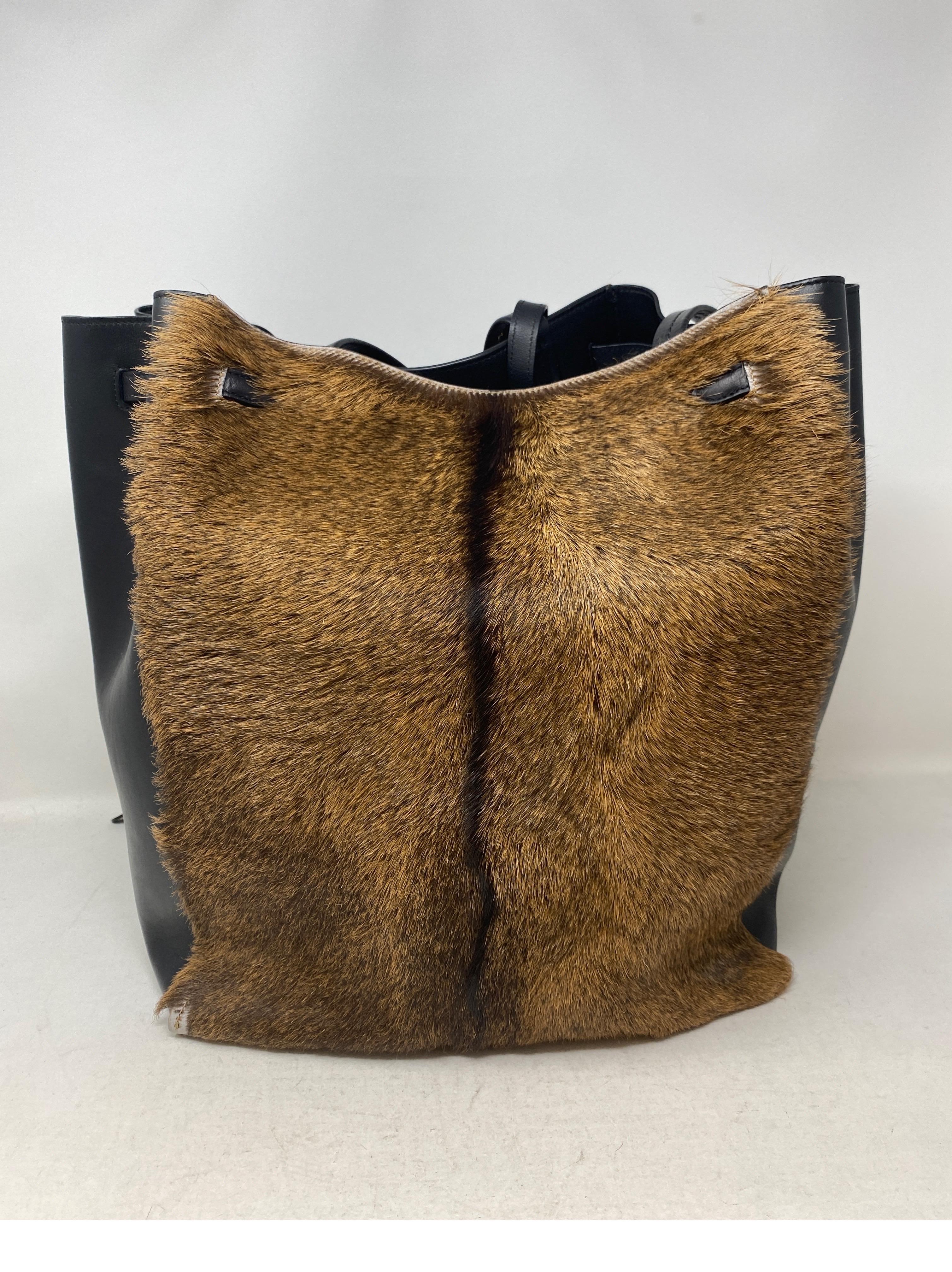 Celine Pony Hair Fur Bag. Black leather and pony hair combination. Cinched bag on top or can be worn open as a tote. Has corner wear. Please look at photos. Interior clean. Overall good condition accept for one corner. Comes with original tags and