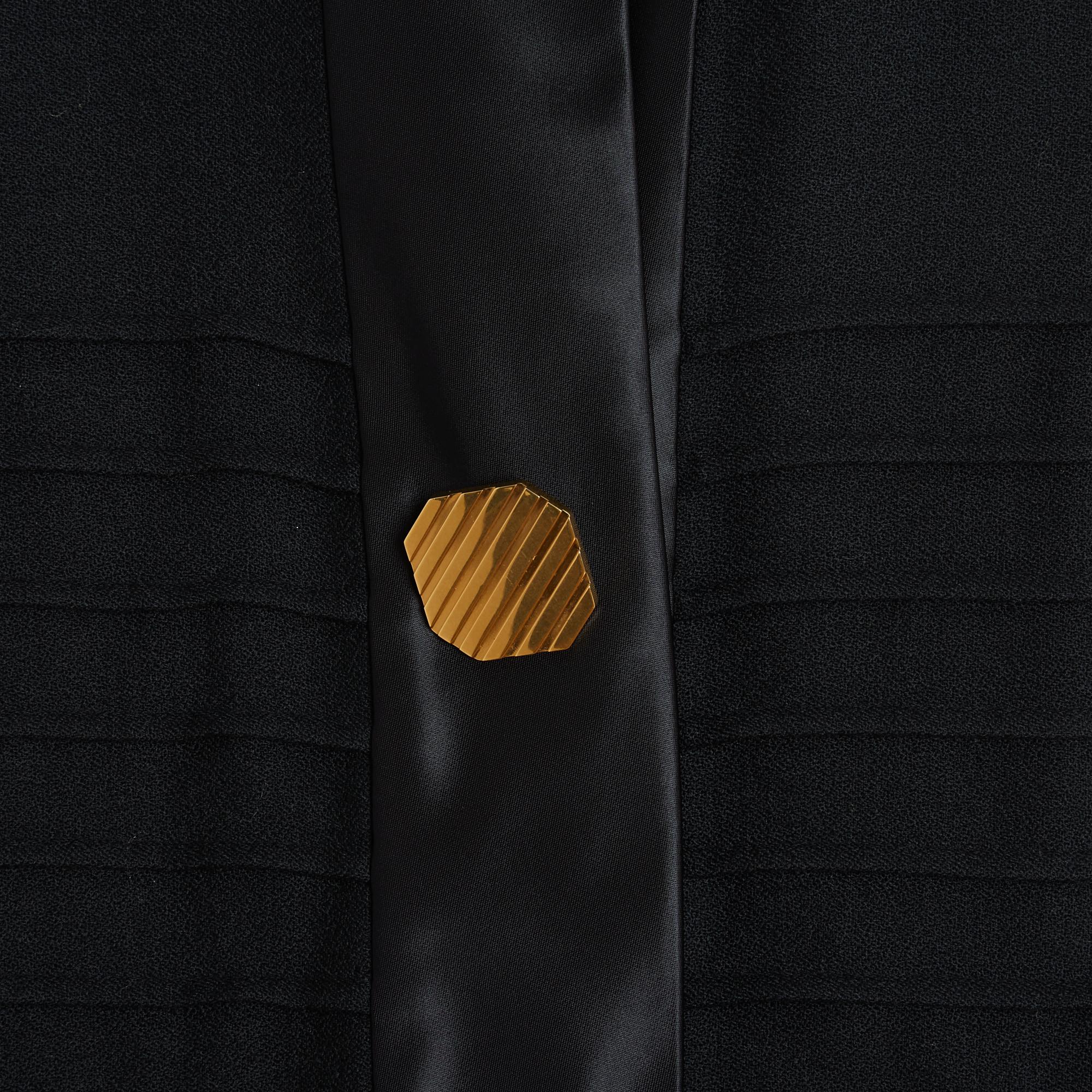 Céline dress from the Pre Fall 2014 collection by Phoebe Philo in thick black wool crepe, small black satin canvas stand-up collar, slit all the way up and closed with a jewel button in the center, sleeveless, skirt with wide flat pleats, 2 slit