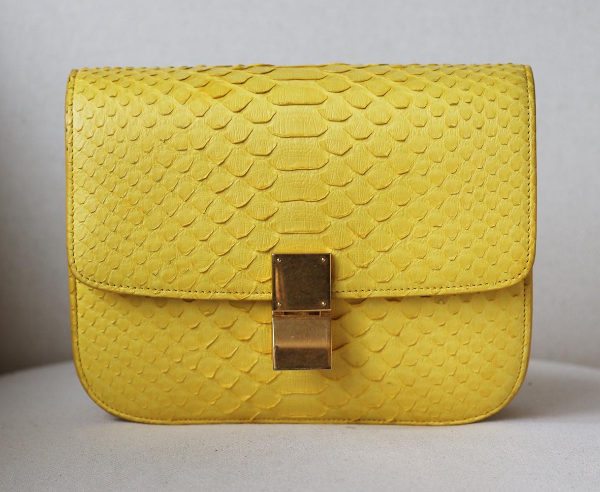This shoulder bag has been made in France from bright-yellow python-leather with Celine's iconic gold-tone fastening.
The pushlock fastening opens to reveal a yellow leather interior. 
Can be carried by its python leather and leather strap.
Yellow