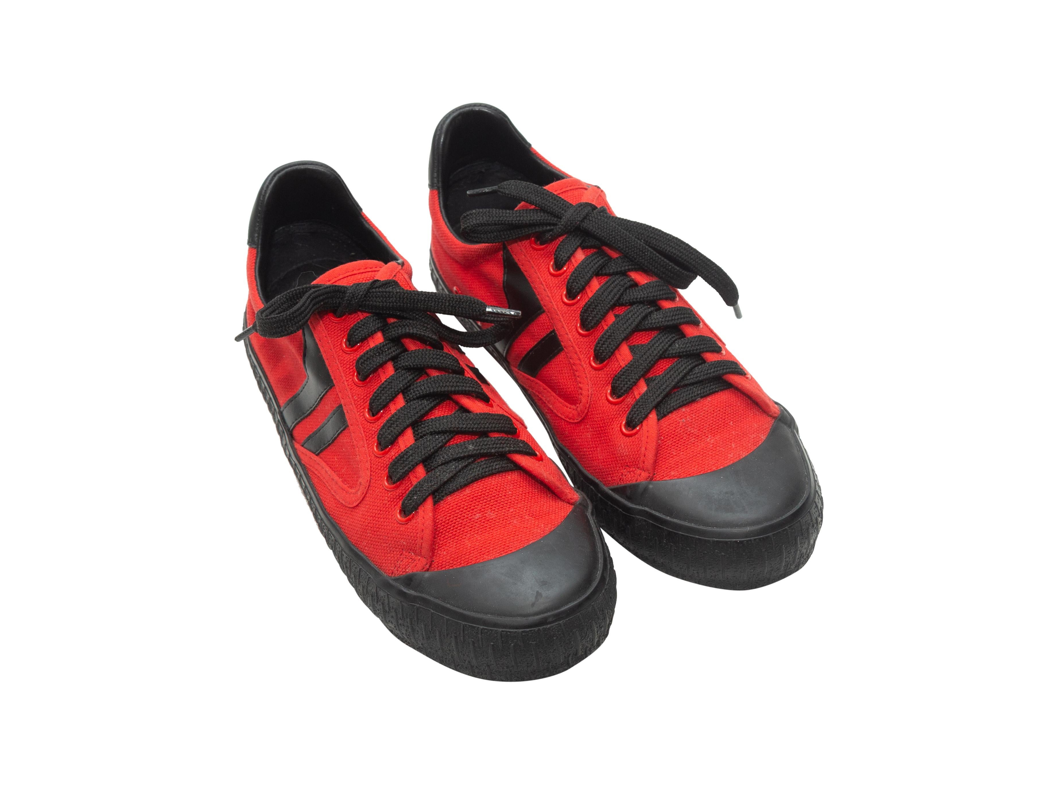 Product details: Red and black canvas Plimsole low-top sneakers by Celine. Rubber cap-toes. Lace-up tie closures at tops. Designer size 38. 1