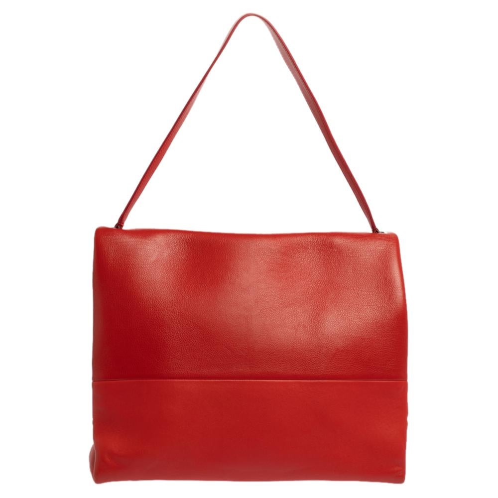 Minimalist charm for the everyday woman reigns the chic brand, Céline. This Celine All Soft shoulder bag with a striking look is perfect for the modern woman. Crafted from red-colored leather, this minimalist tote features a single shoulder strap,