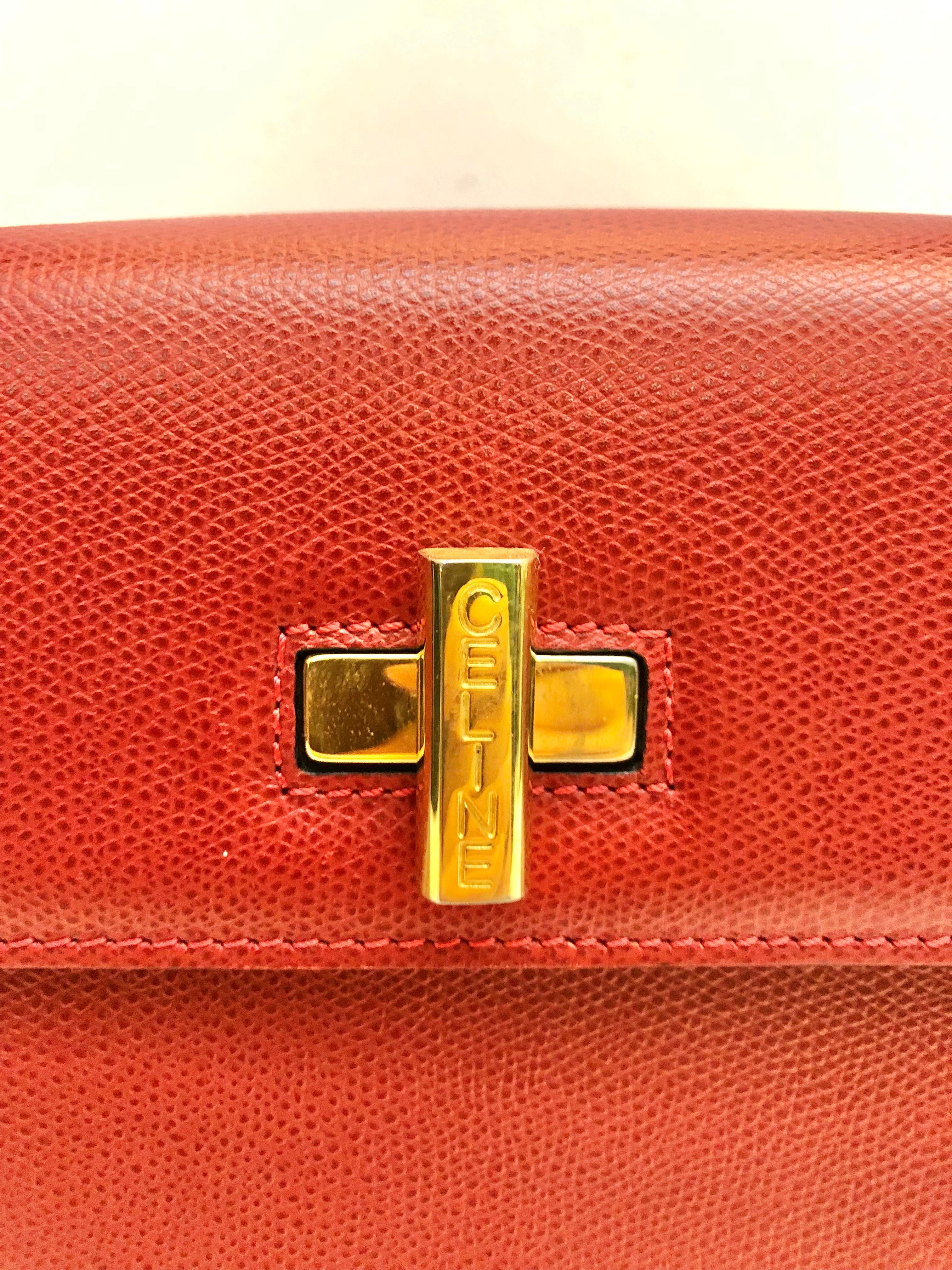 - Vintage Celine red leather box handbag.

- Gold hardware “CELINE” turn-lock closure. 

- Red leather interior. 

- One interior zip pocket.Two interior slip  pockets. 

- Size: 26cm x 20cm x 9.5 cm. Handle Drop: 12cm. 