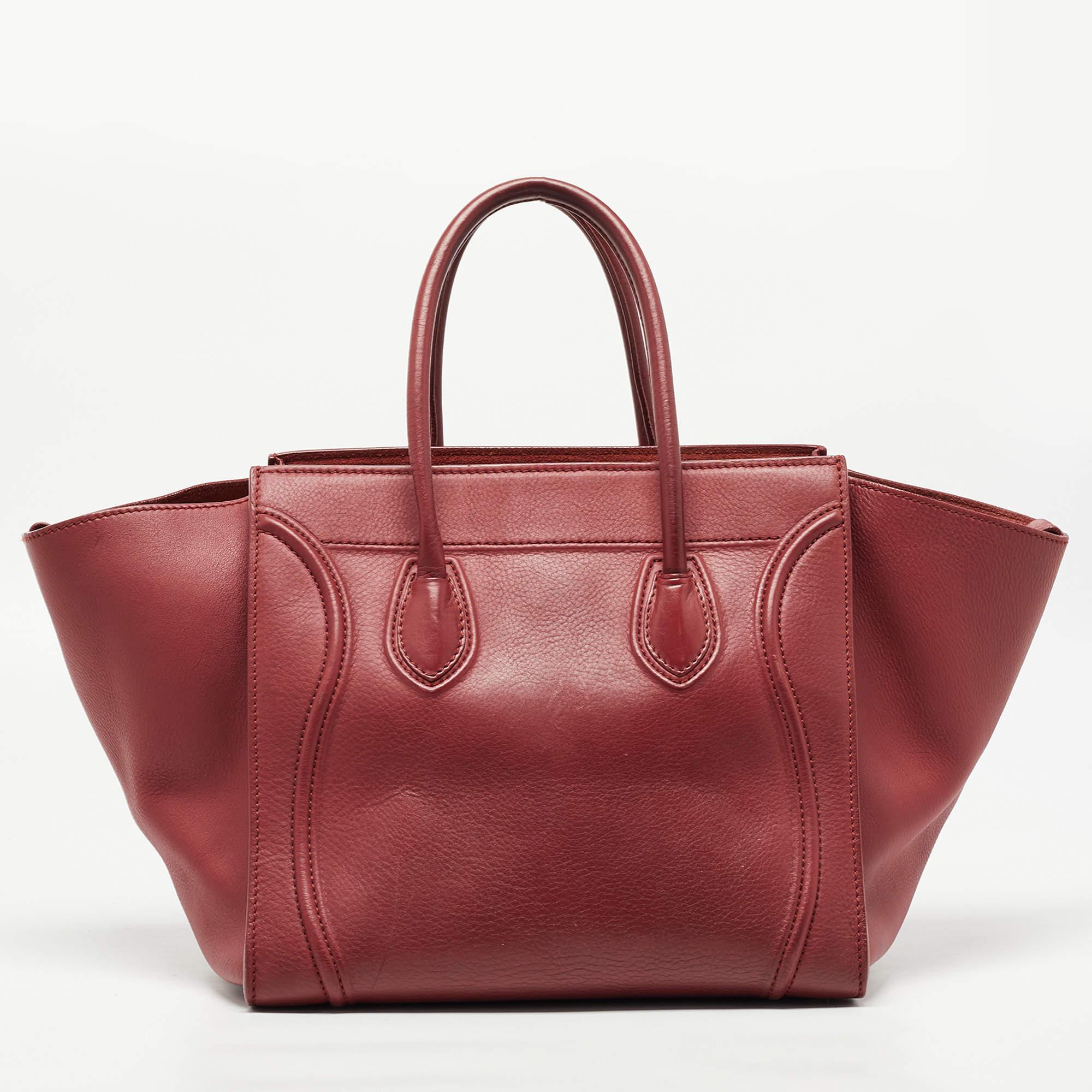 The phantom by Celine is a modernized update of the luggage bag by the brand. This tote has been constructed from python leather, and the design is highlighted with a wide wingspan, and its front zipper pocket is equipped with a braided slider. The
