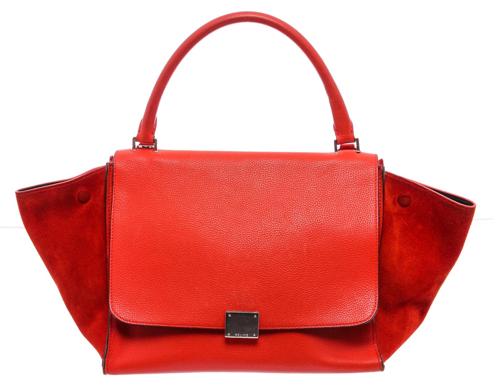 Red leather Céline Medium Trapeze bag with gold-tone hardware, single detachable flat shoulder strap, single rolled top handle, single exterior zip pocket, snap expansions at sides, suede panels at sides, black leather lining, dual interior slit