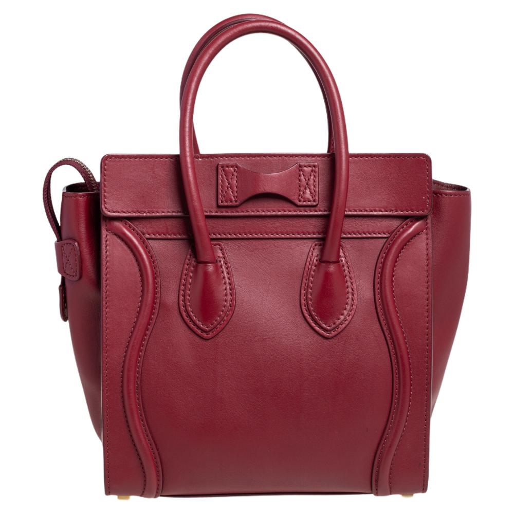 The Luggage tote from Celine is one of the most popular handbags in the world. This tote is crafted from leather and designed in a red shade. It comes with rolled top handles and a front zip pocket. The bag is equipped with a well-sized leather