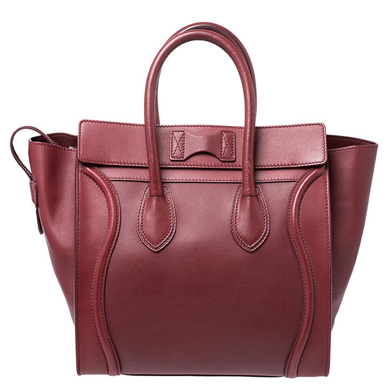 The mini Luggage tote from Celine is one of the most popular handbags in the world. This tote is crafted from leather and designed in a red shade. It comes with rolled top handles, protective metal feet and a front zip pocket. The bag is equipped