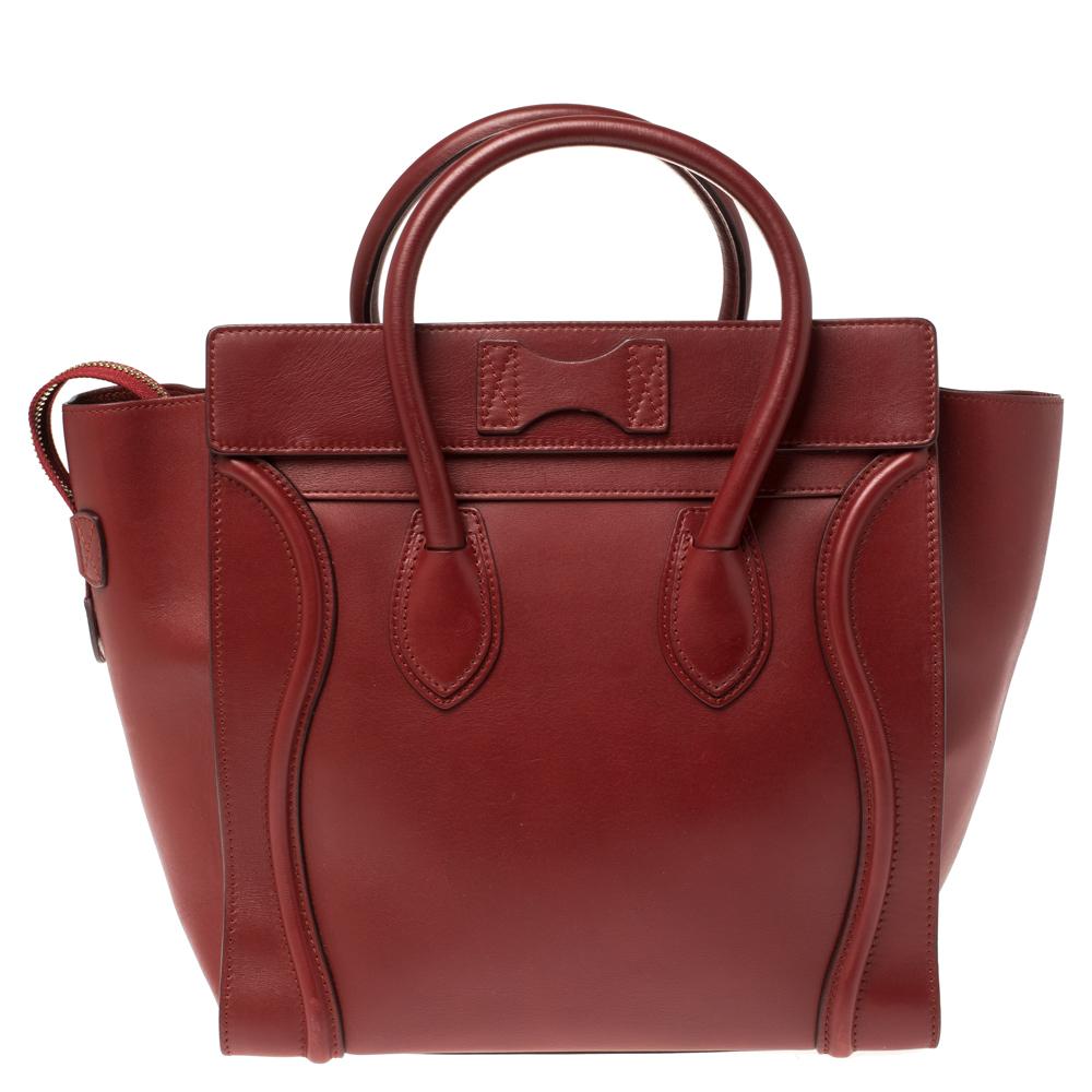 The Luggage tote from Celine is one of the most popular handbags and will become your favorite in no time. It is crafted from red leather and comes with rolled top handles and a front zip pocket. The bag is equipped with a well-sized leather