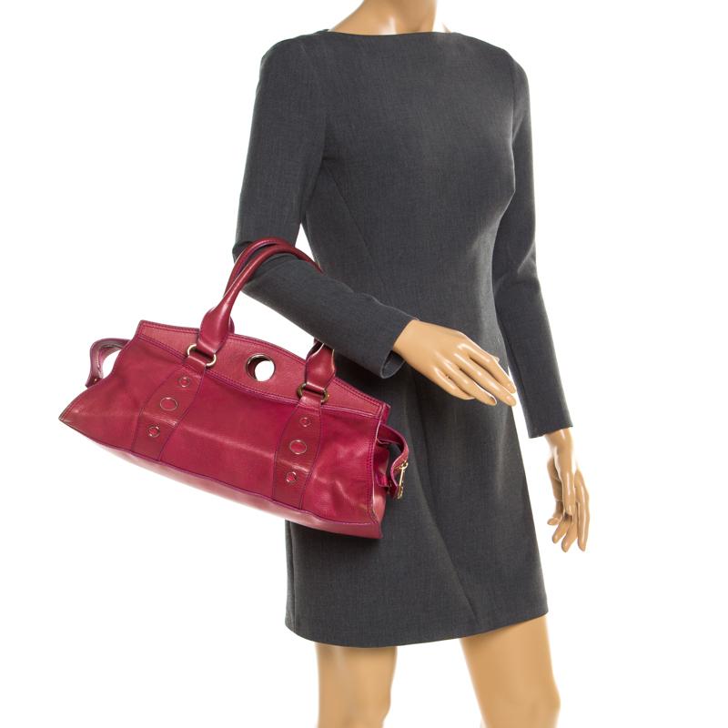 Crafted in a stunning red, this bag is an ageless investment. This Celine satchel flaunts an unbelievable style and is made of leather. The bag features dual handles and a fabric lined interior that is secured by a zip top closure.

Includes: The