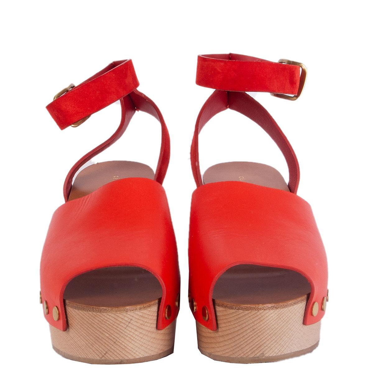 100% authentic Céline clog open toe sandals in red calfskin with a beige wooden sole featuring gold-tone studs. Have been worn once and are in virtually new condition. 

Measurements
Imprinted Size	39
Shoe Size	39
Inside Sole	25.5cm