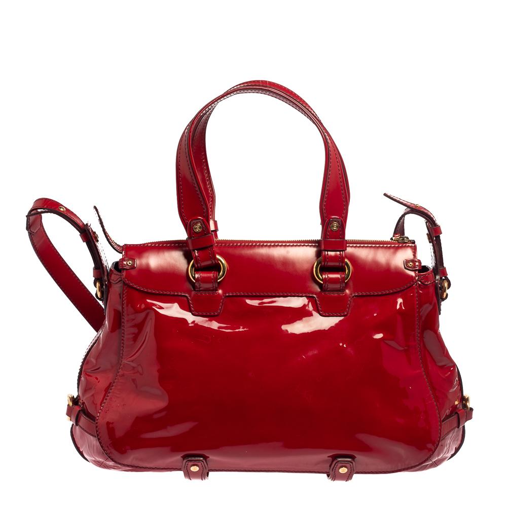 Celine's finest range of totes includes this beauty here. It is crafted using patent leather and held by two top handles and a shoulder strap. The designer red tote is lined with fabric and complemented with gold-tone