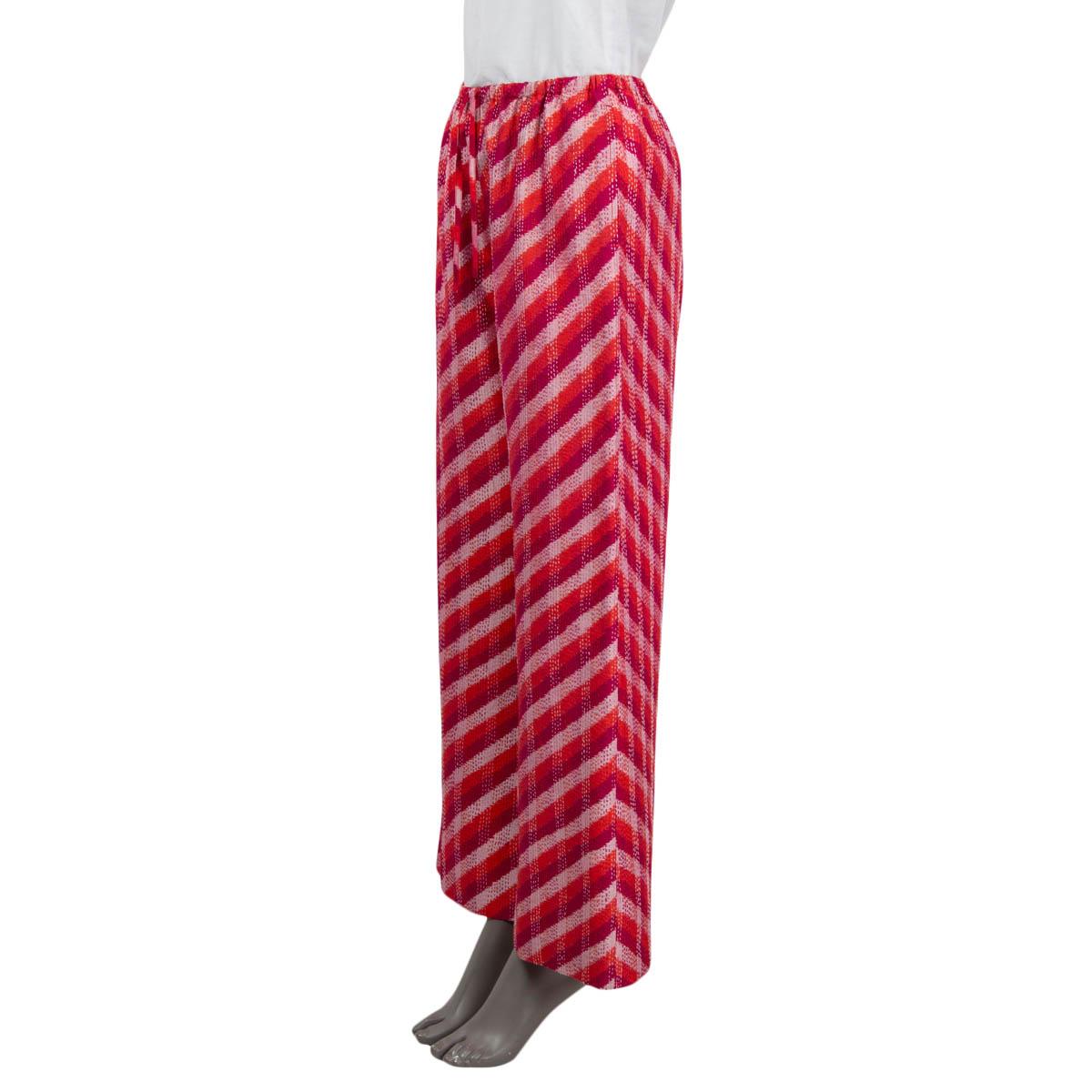 100% authentic Dries Van Noten 2022 'IKAT' wide leg pants in red, purple and dusty rose silk (100%). Feature a diagonal striped print and two side slit pockets. Open with a drawstring and have an elastic waistband. Pockets lined in red silk (100%).