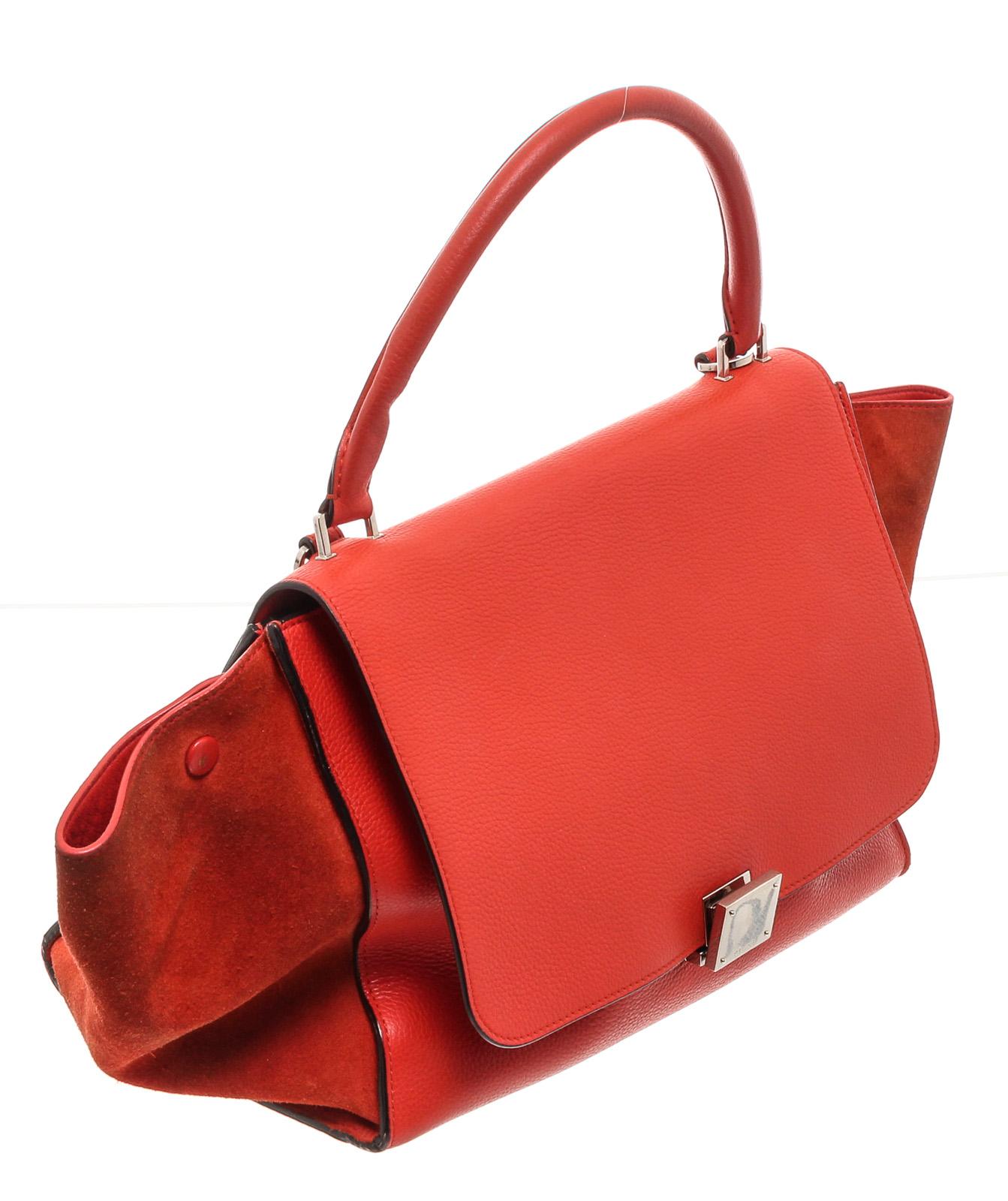 Red leather Céline Small Trapeze Bag with silver-tone hardware, single rolled top handle, detachable flat shoulder strap, dual side gussets with snap expansions at sides, exterior zip pocket at back, tonal leather lining, dual interior slit pockets