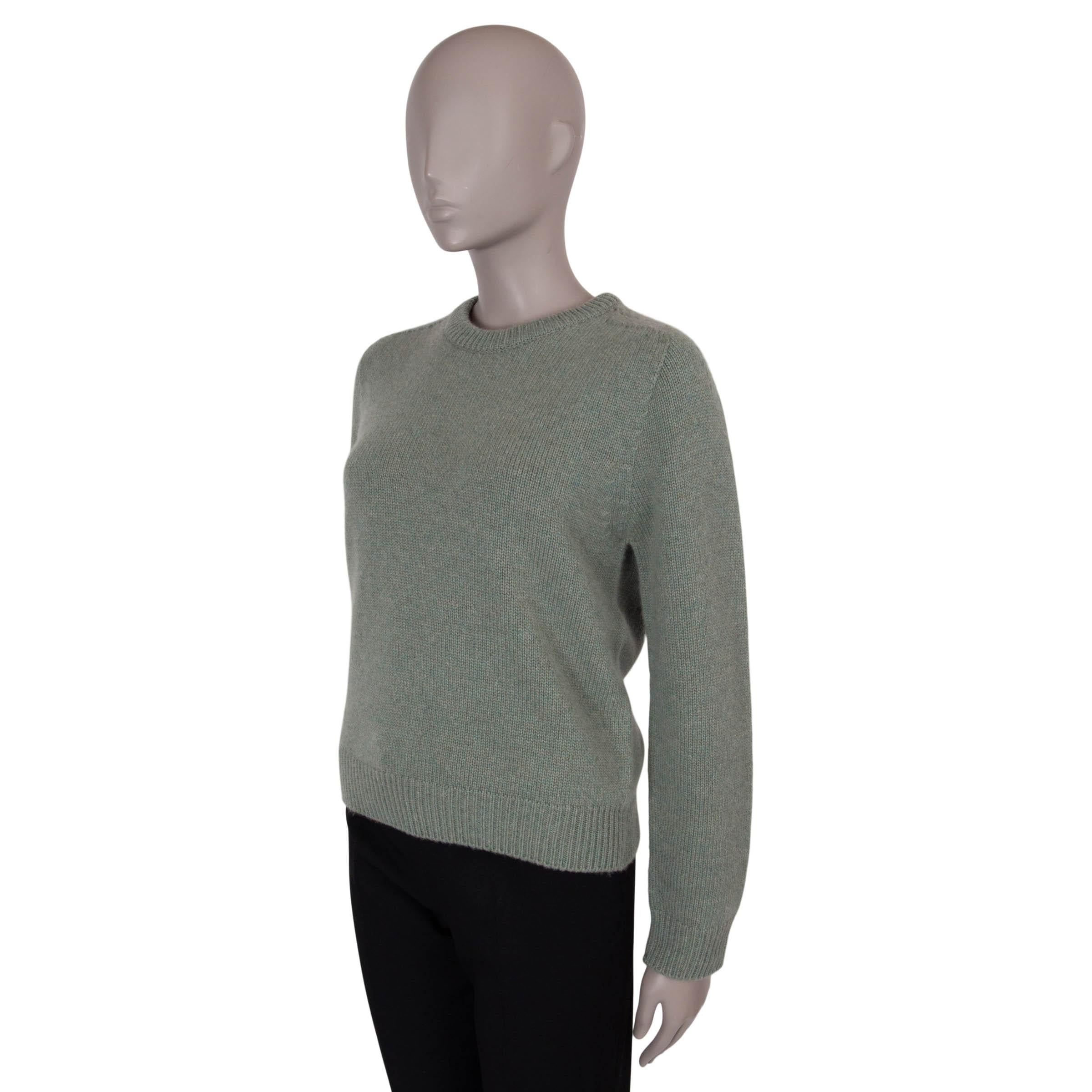 This 100% authentic Celine cashmere crewneck sweater in a serene sage green hue exudes effortless luxury and sophistication. Crafted from premium cashmere, it offers a supremely soft and cozy feel. Featuring a slightly boxy cut, it provides a modern