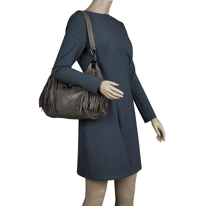 This hobo bag is luxurious, with soft black leather and a jewel accent on the metal tab close. The 33cm drop handles are the perfect length to sling over your shoulder comfortably and there is a selection of inner pockets. This beautiful bag is