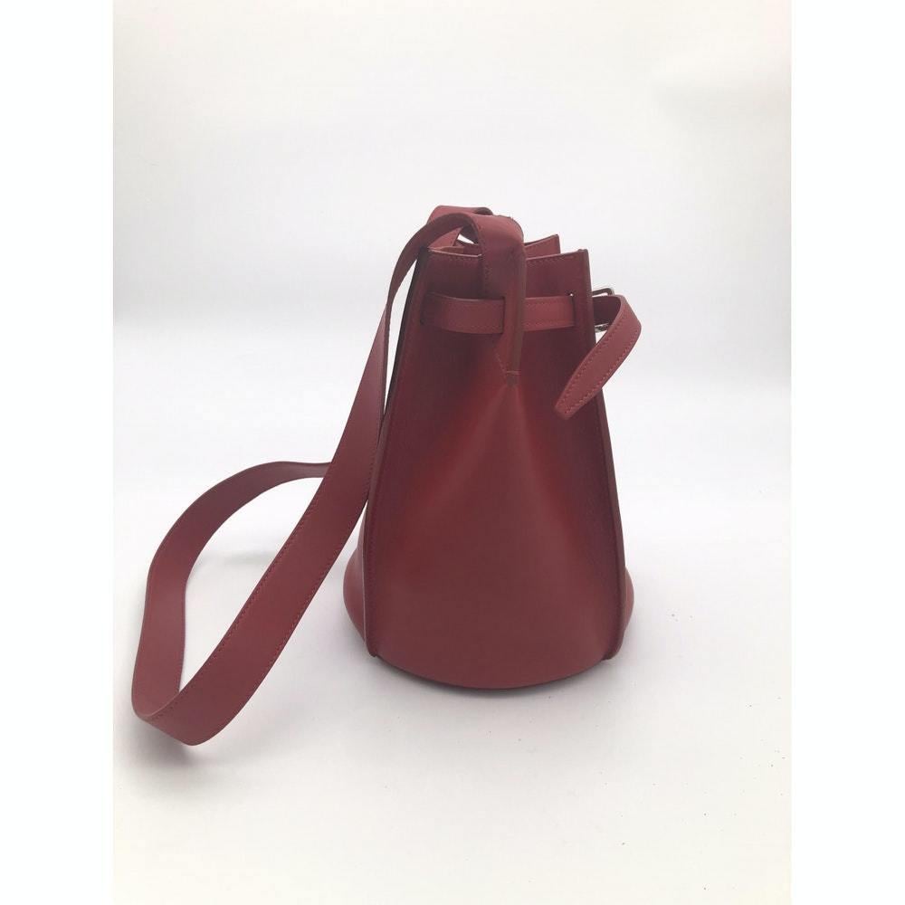 - Designer: CÉLINE
- Model: sangle
- Condition: Very good condition. 
- Accessories: Dustbag
- Measurements: Width: 24cm, Height: 23cm, Depth: 20cm, Strap: 94cm
- Exterior Material: Leather
- Exterior Color: Red
- Interior Material: Suede
- Interior