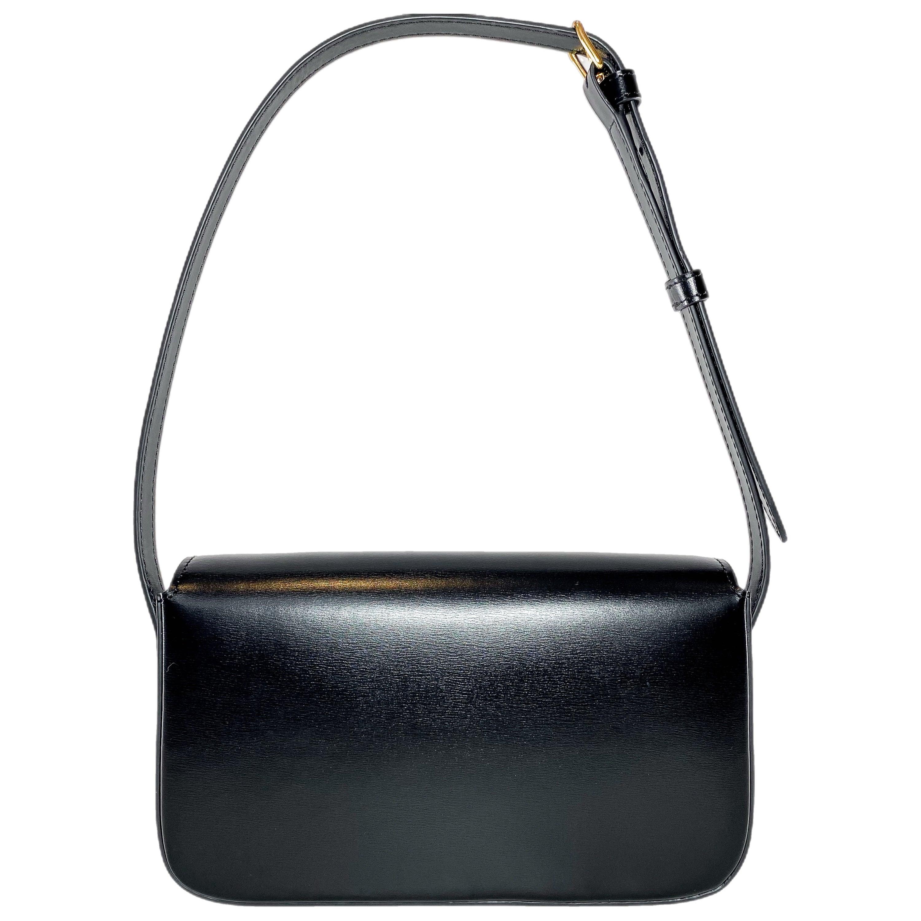 The bag features a Triomphe push closure closure, gold tone hardware, a front flap, an interior with leather lining and a patch pocket.

Color: Black
Material: Calfskin leather
Comes with: dust bag
Condition: Excellent. Light used bag with faint